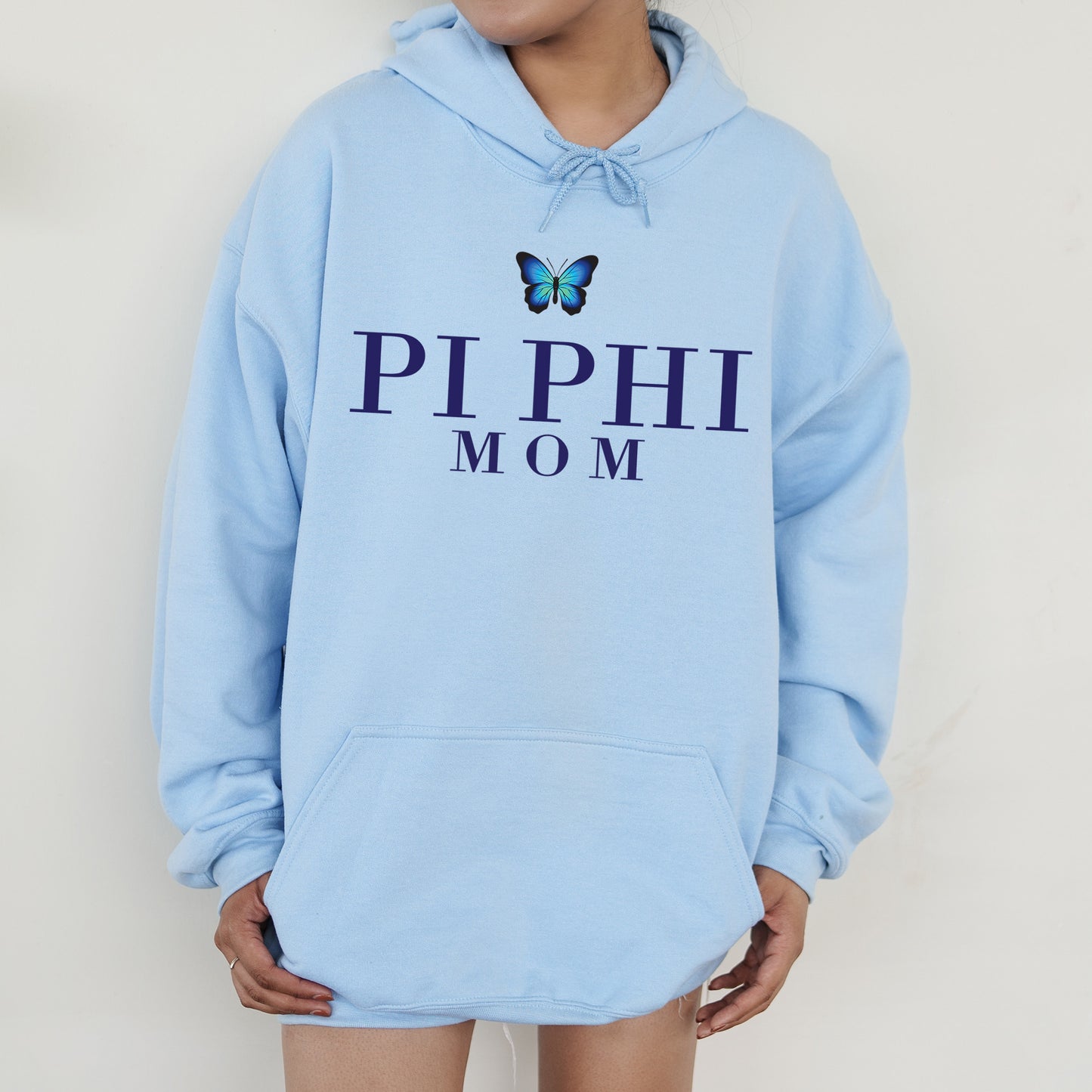 a woman wearing a blue hoodie with a butterfly on it