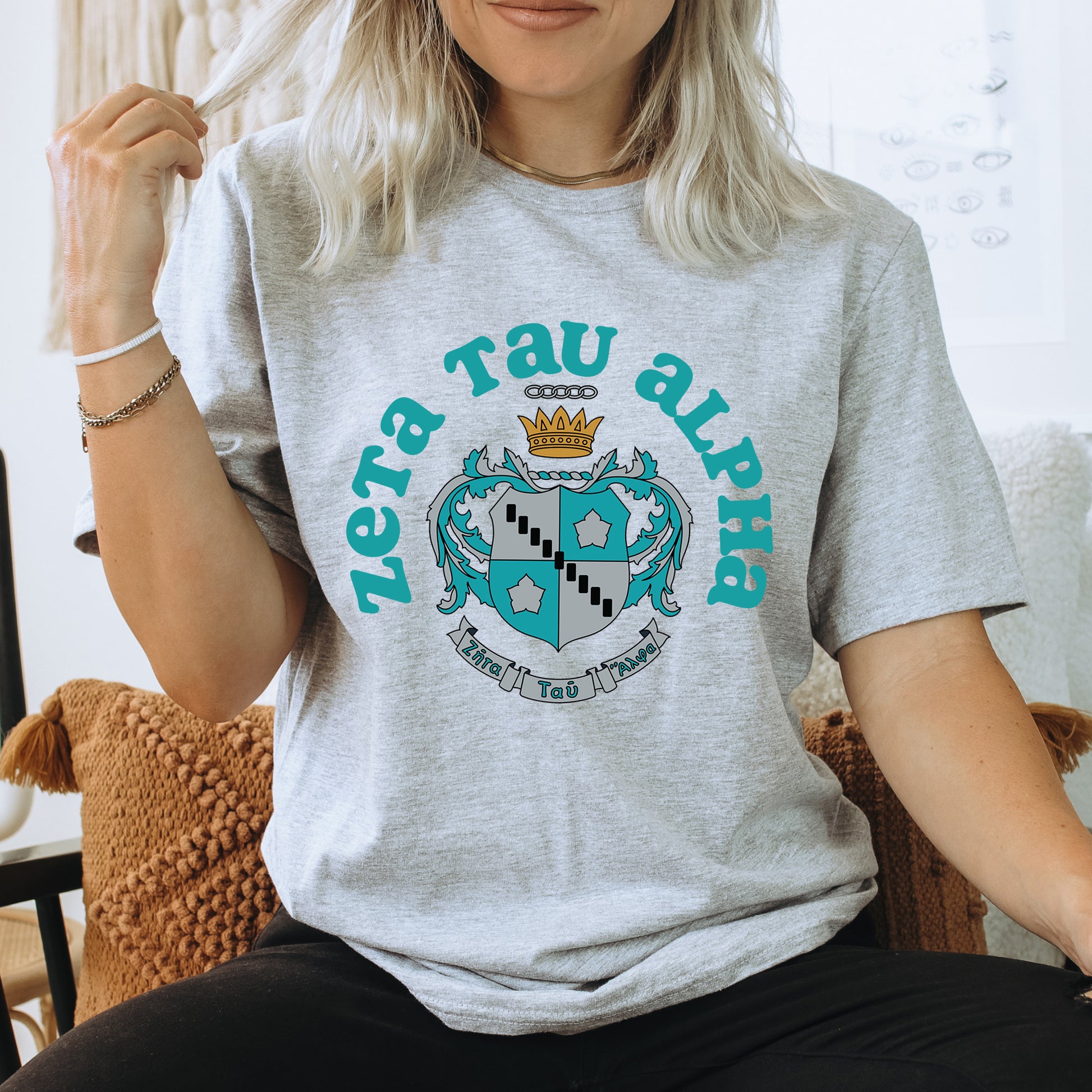 a woman sitting on a chair wearing a t - shirt