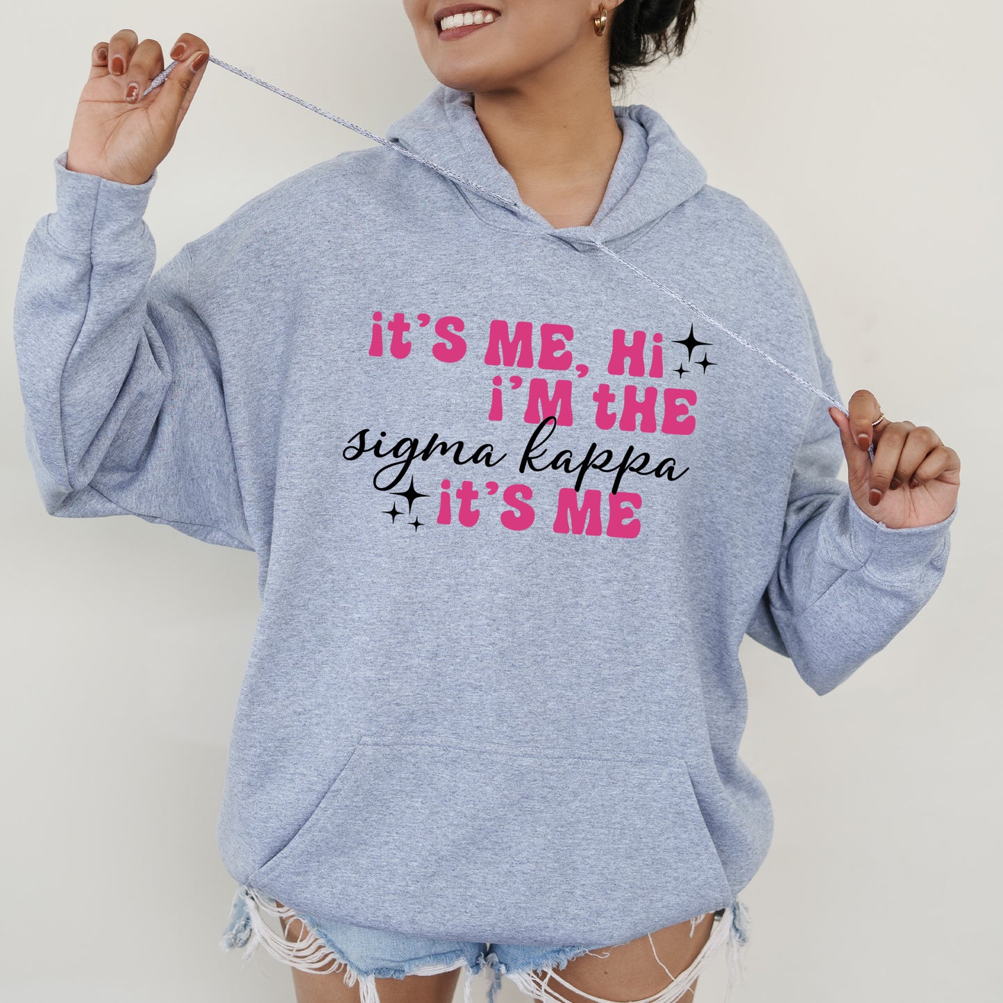 a woman in a blue hoodie holding a toothbrush