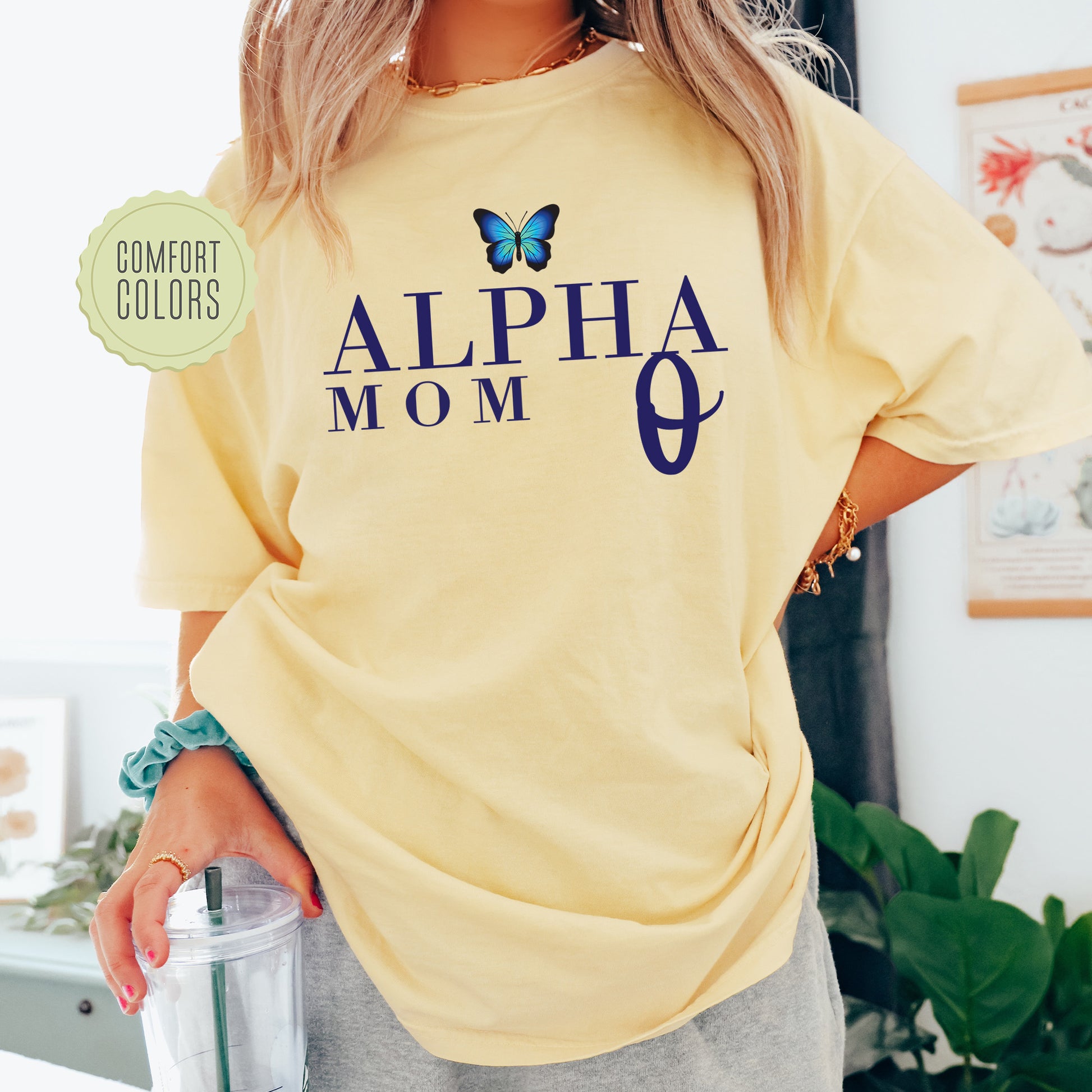 a woman wearing a yellow shirt with a butterfly on it