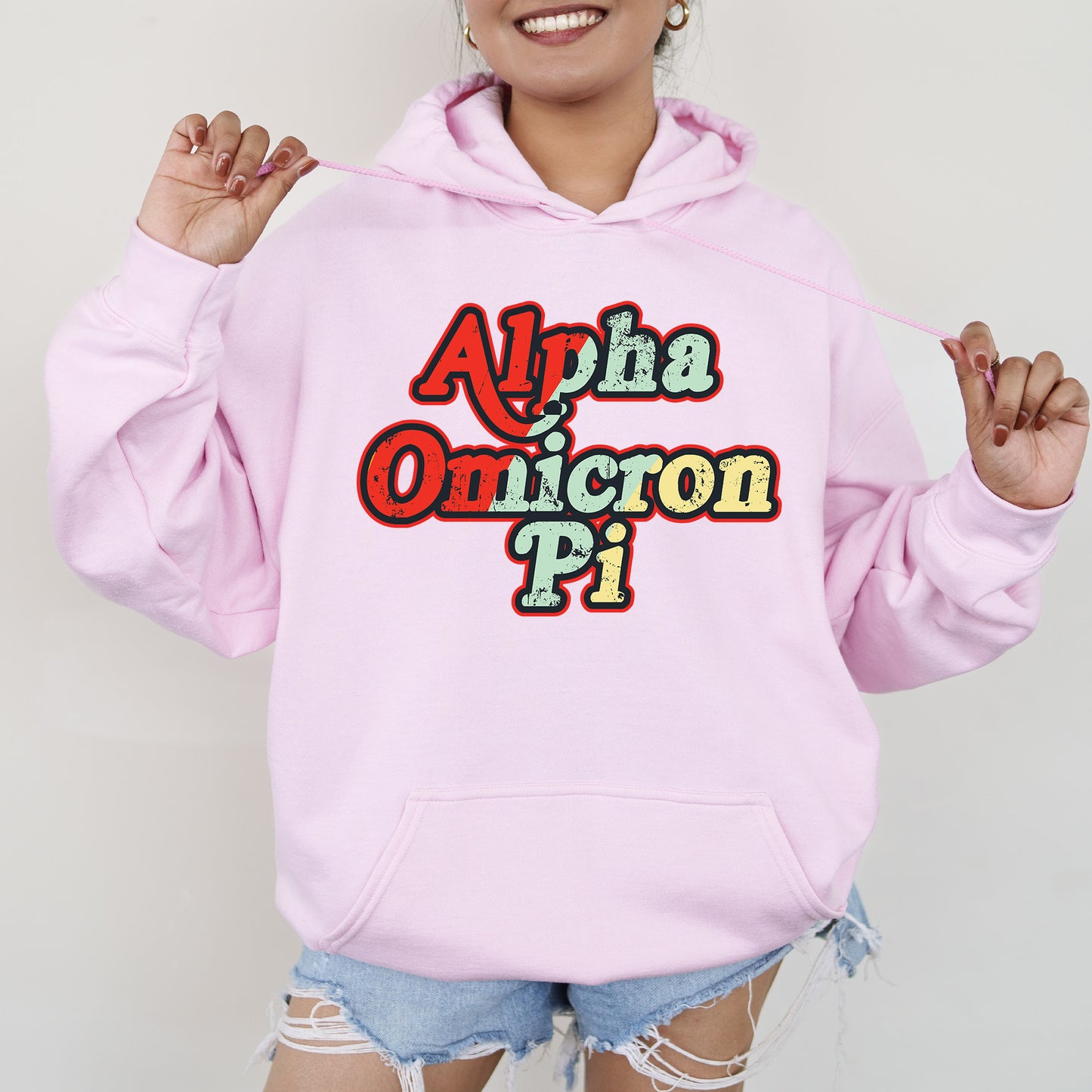 a woman wearing a pink hoodie with the words aloh and unicorn pi on