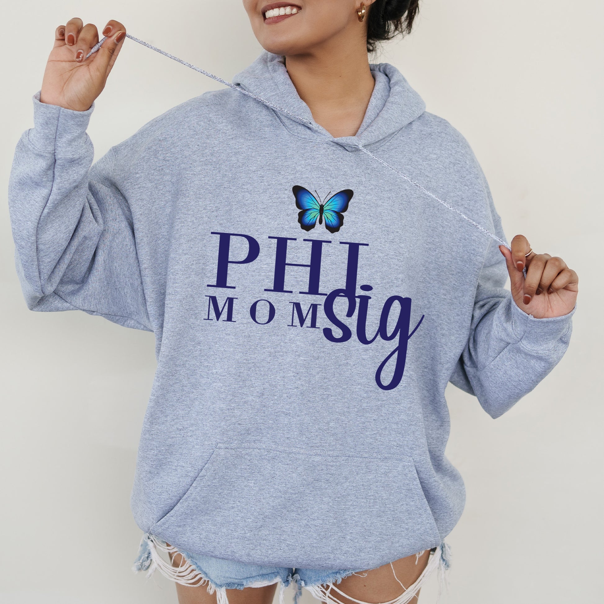 a woman wearing a blue hoodie with a butterfly on it