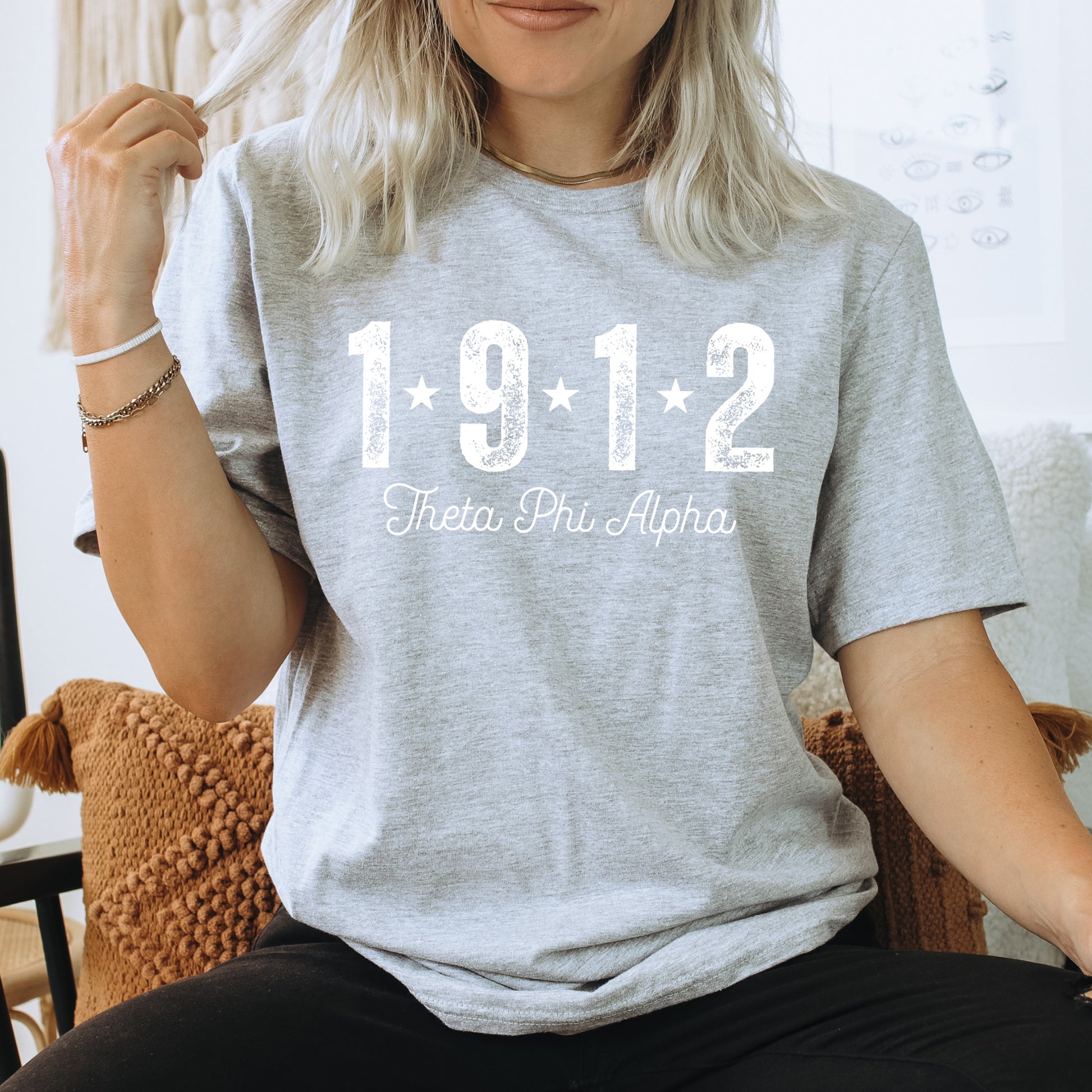 a woman sitting on a chair wearing a t - shirt