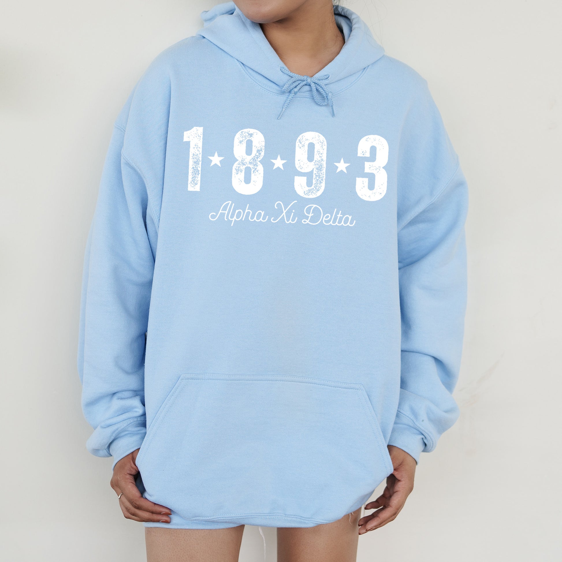 a person wearing a blue hoodie with a white number on it