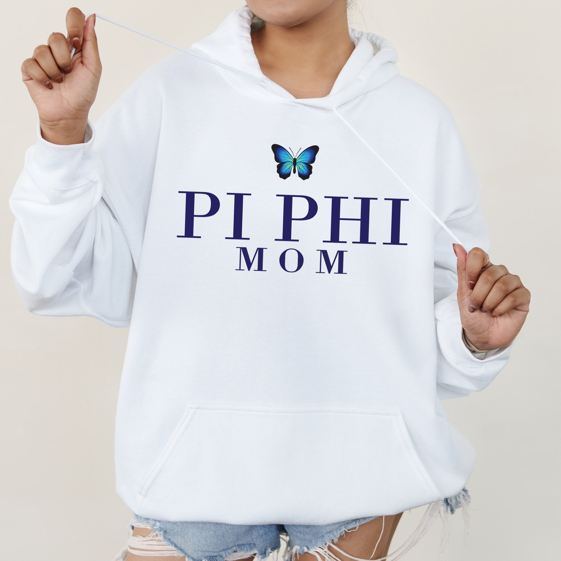 a woman wearing a white hoodie with a butterfly on it