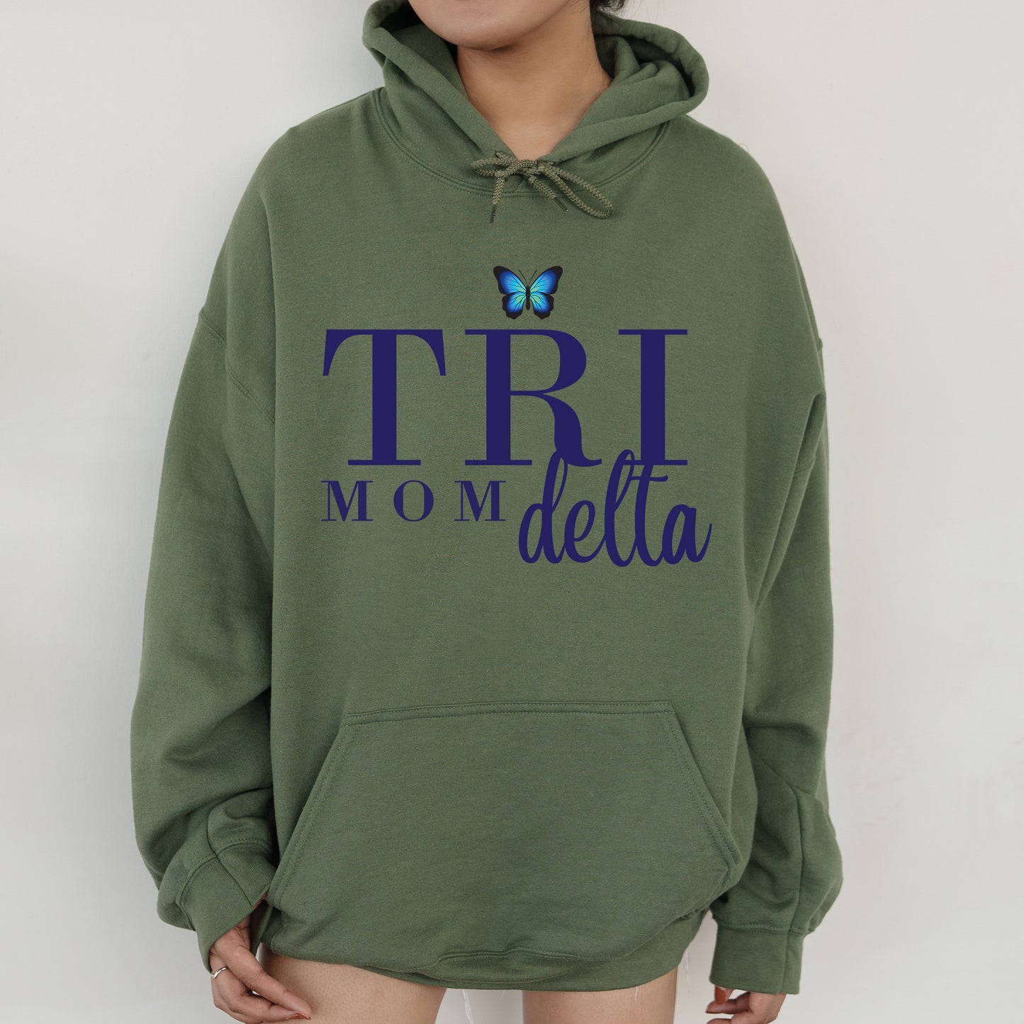 a woman wearing a green hoodie with a butterfly on it