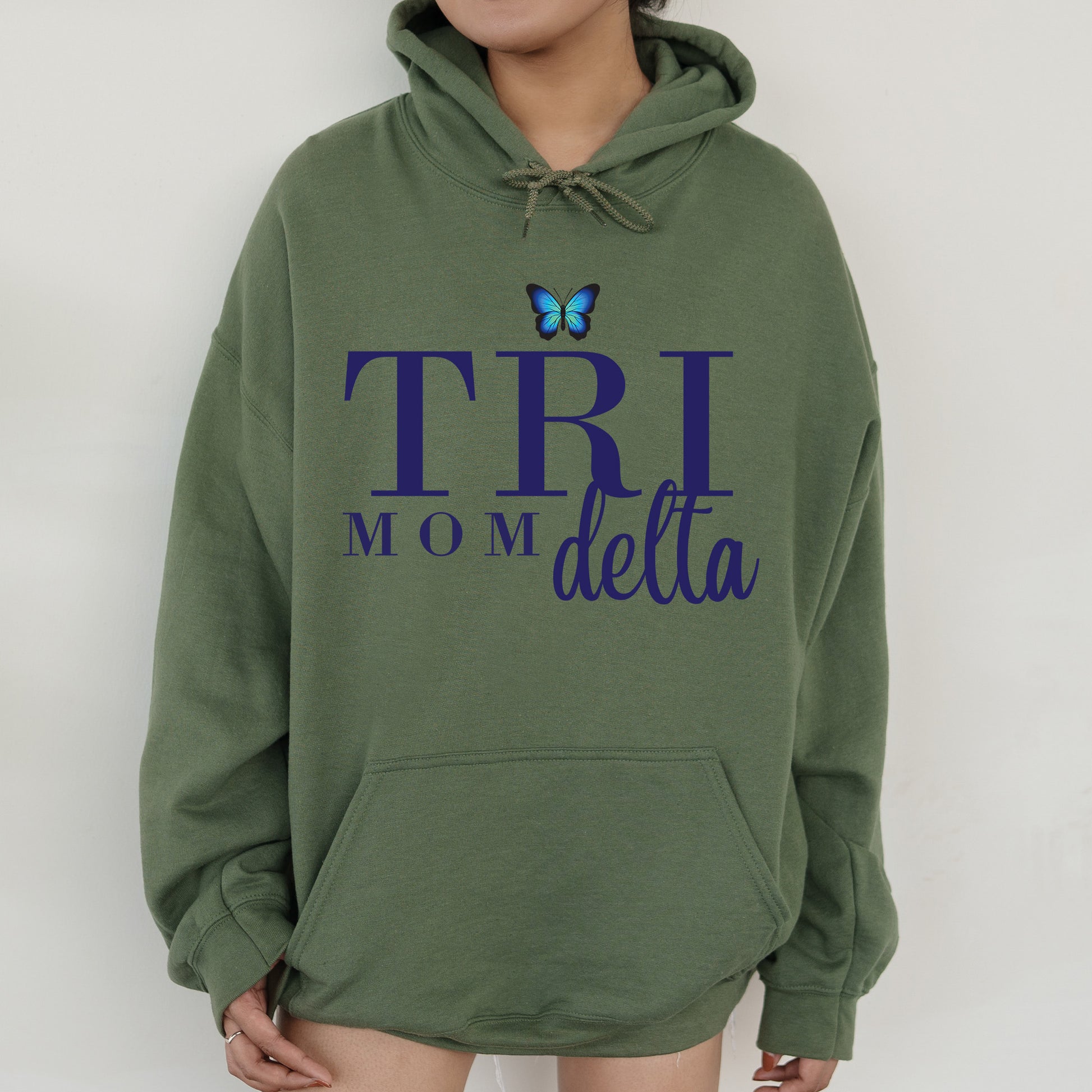 a woman wearing a green hoodie with a butterfly on it