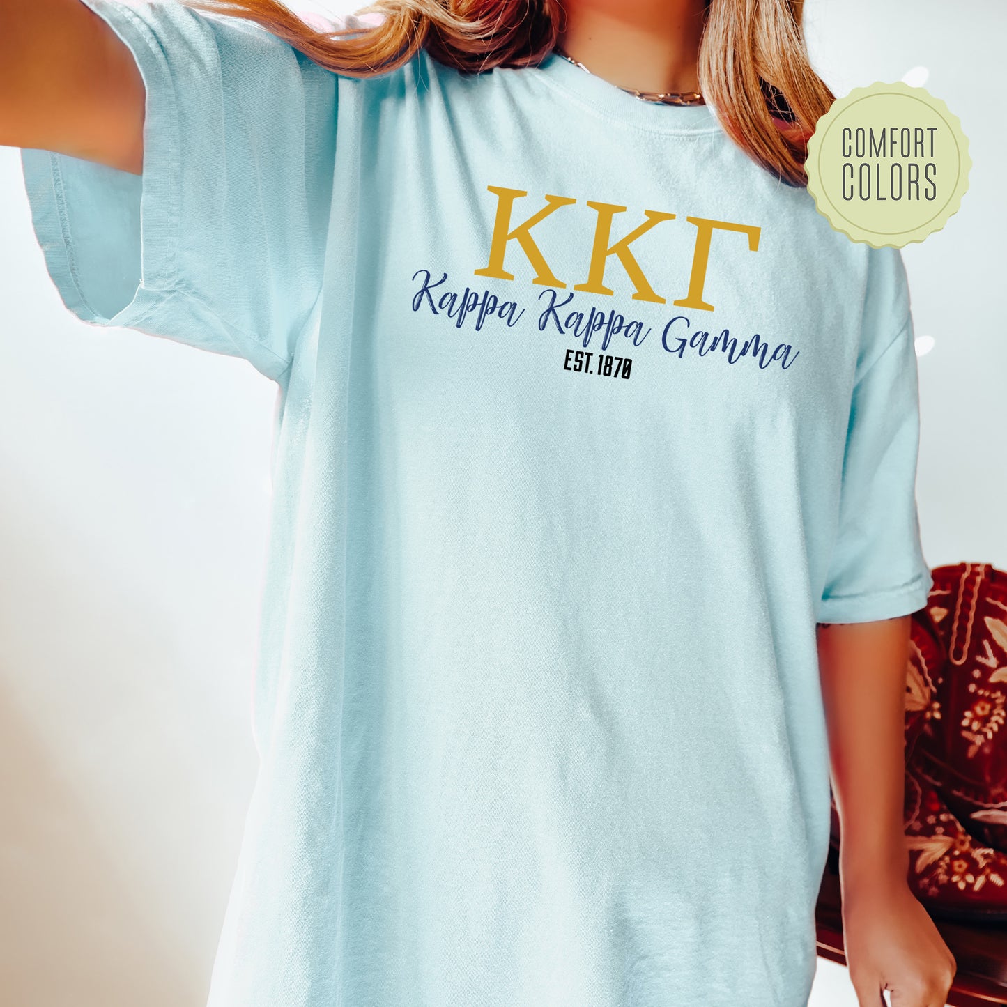 a woman wearing a blue t - shirt with the words kkt on it