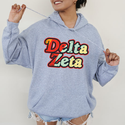 a woman in a blue hoodie holding a toothbrush