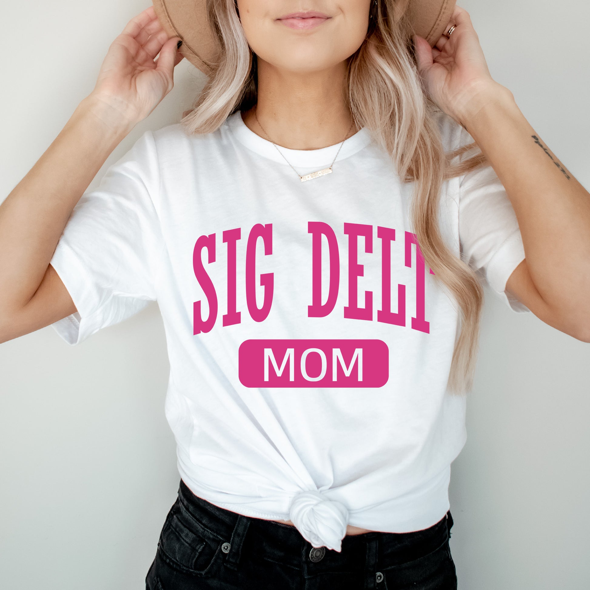 a woman wearing a white shirt with a pink slogan on it