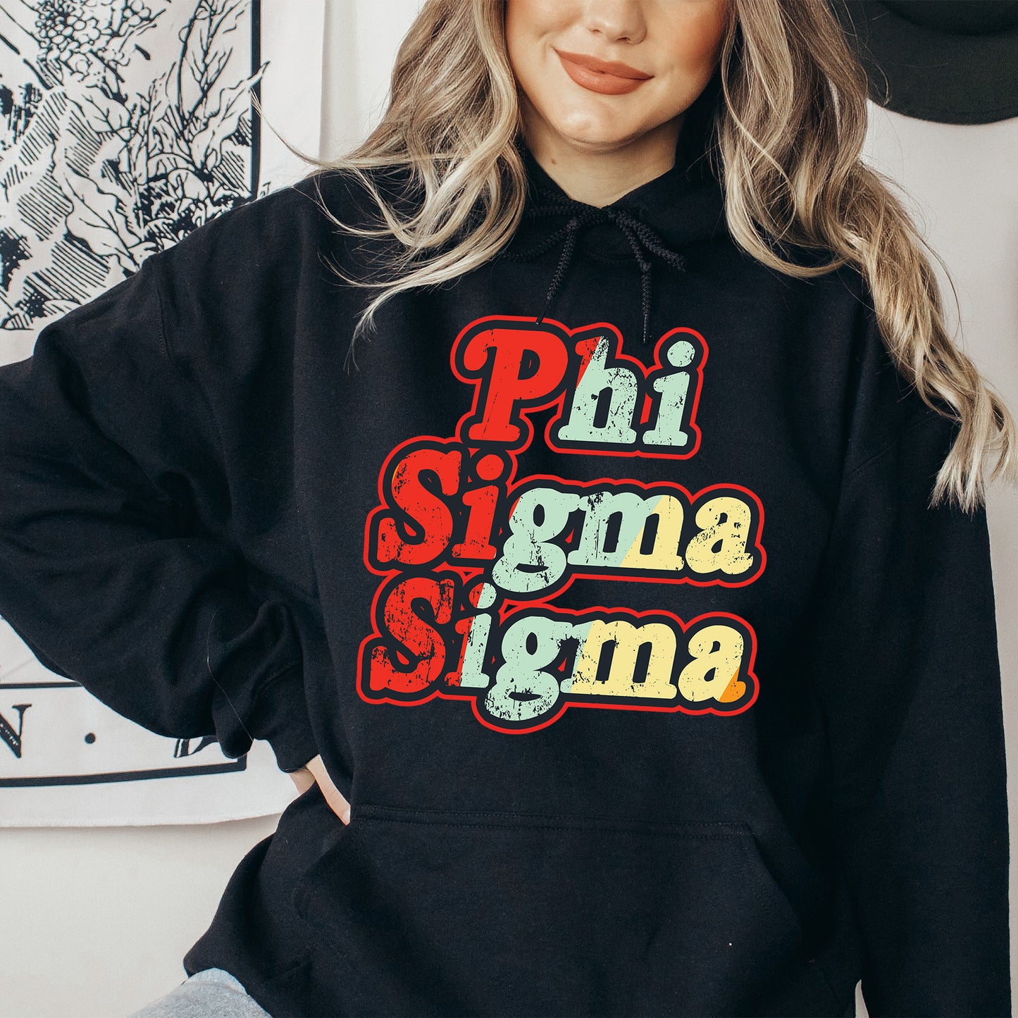 a woman wearing a black hoodie with the words phi sigmama on it