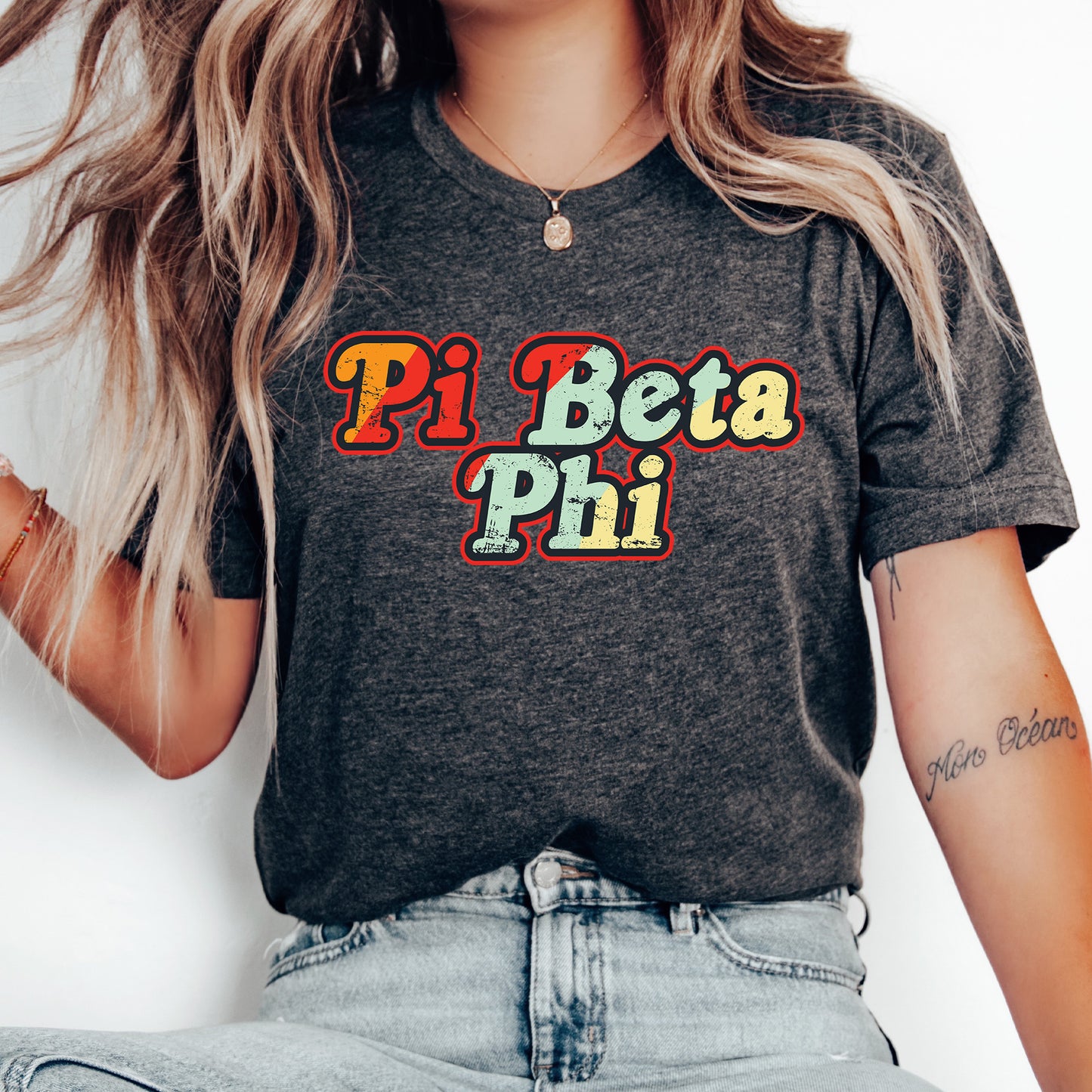 a woman wearing a t - shirt that says pi beta pii