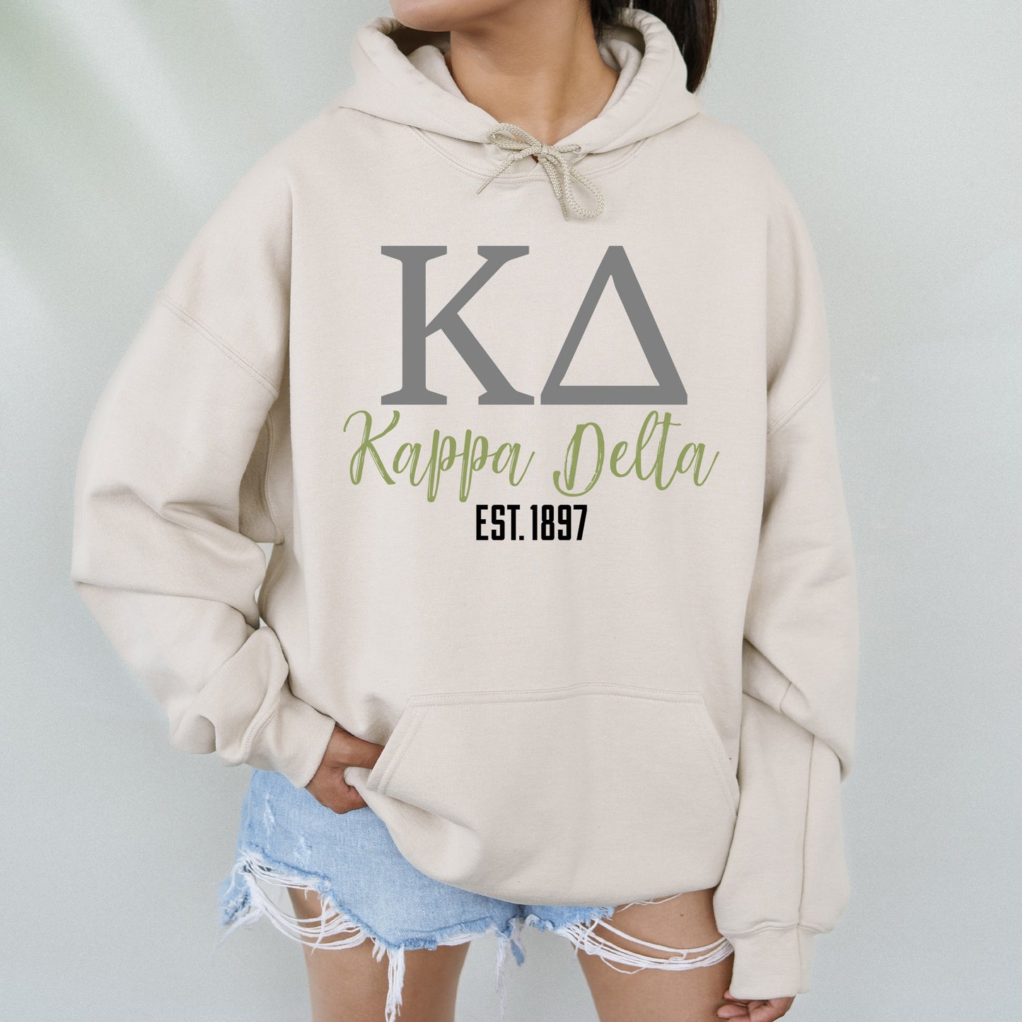 a woman wearing a sweatshirt with the letters kapaa dela on it