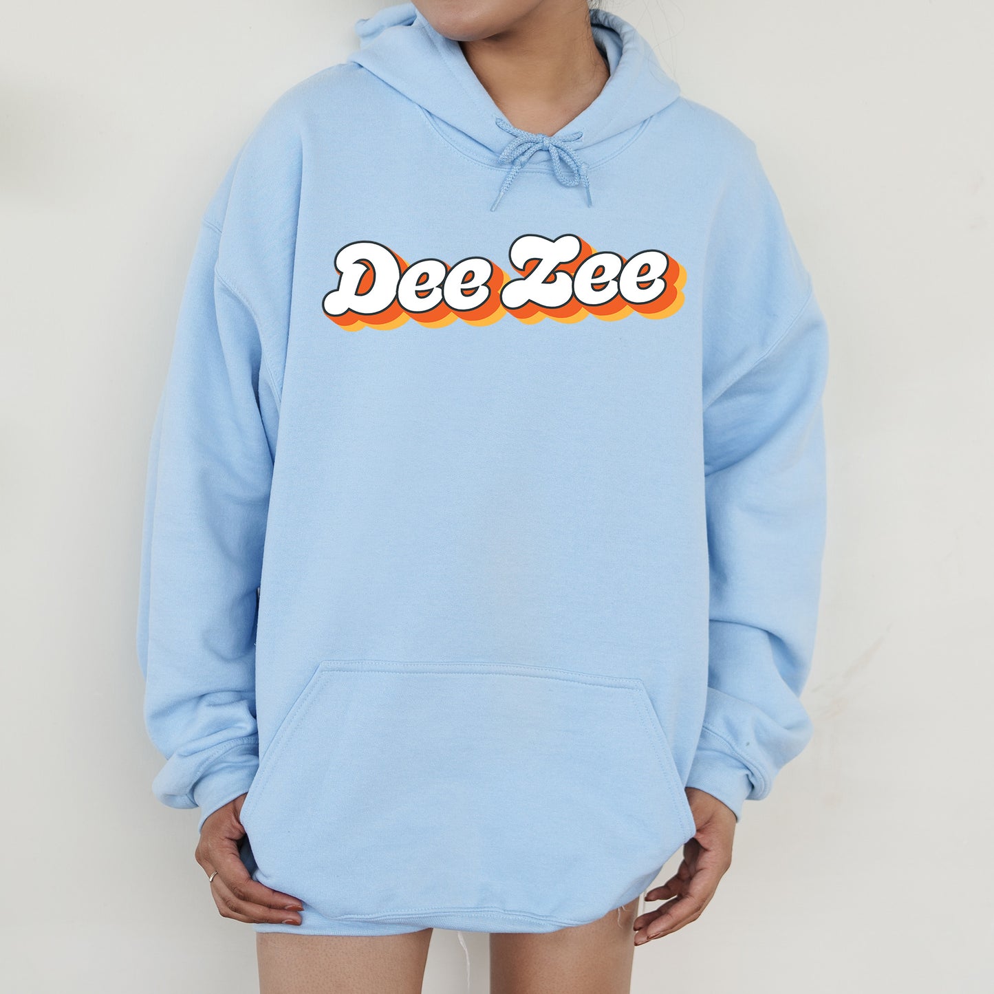 a person wearing a blue hoodie with the word dee zee on it