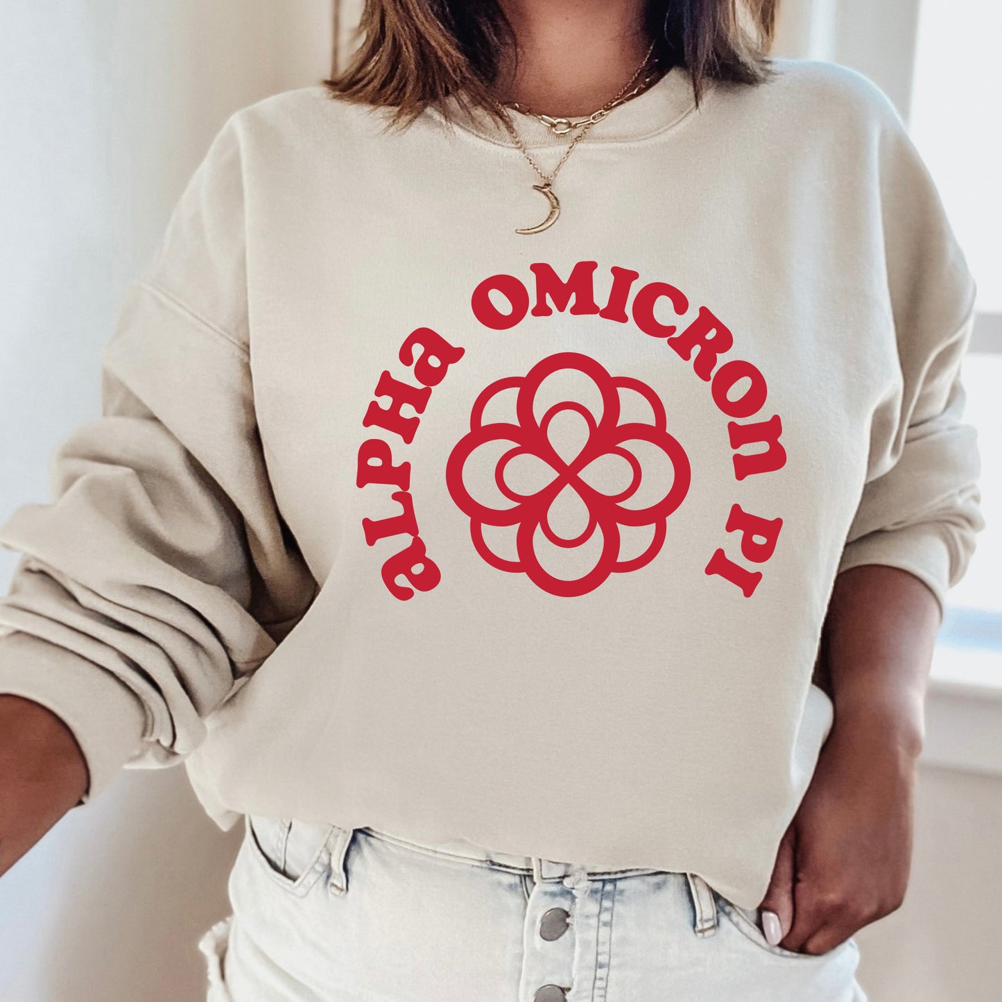 a woman wearing a white sweatshirt with a red logo