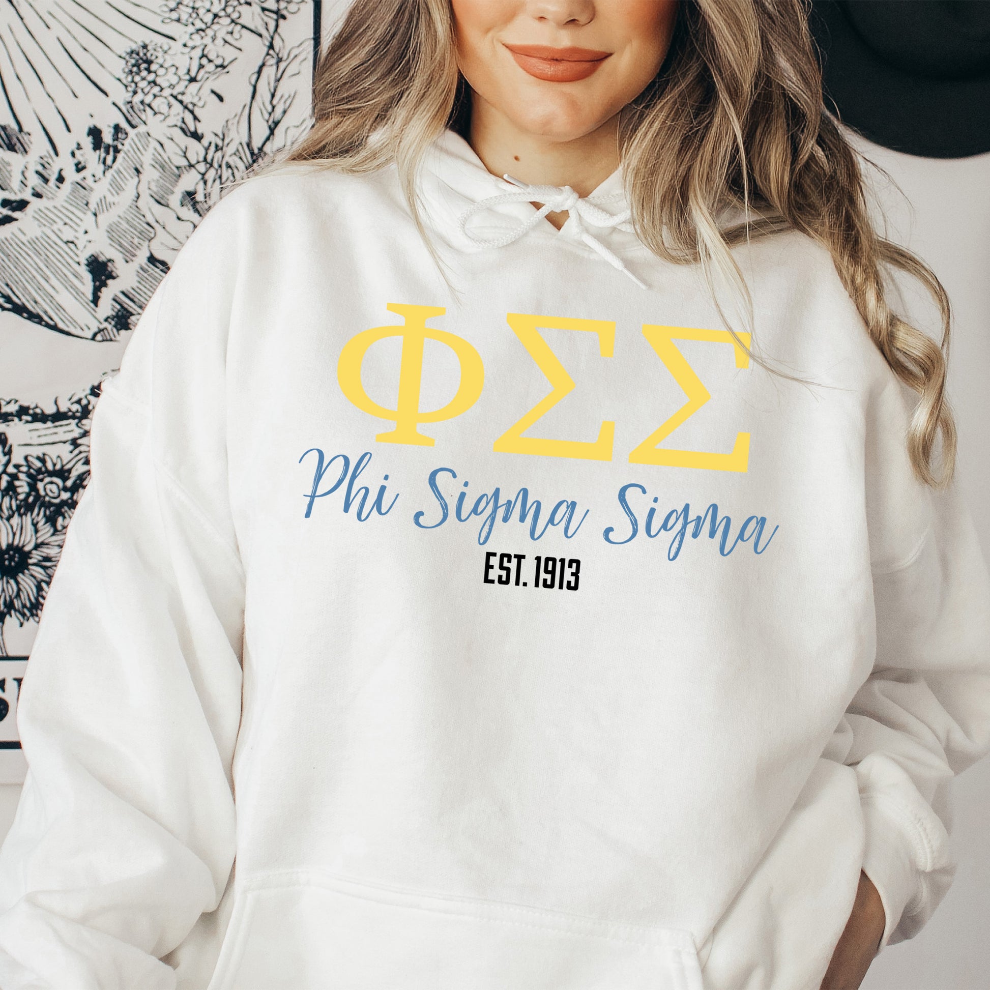 a woman wearing a white phi phi phi hoodie