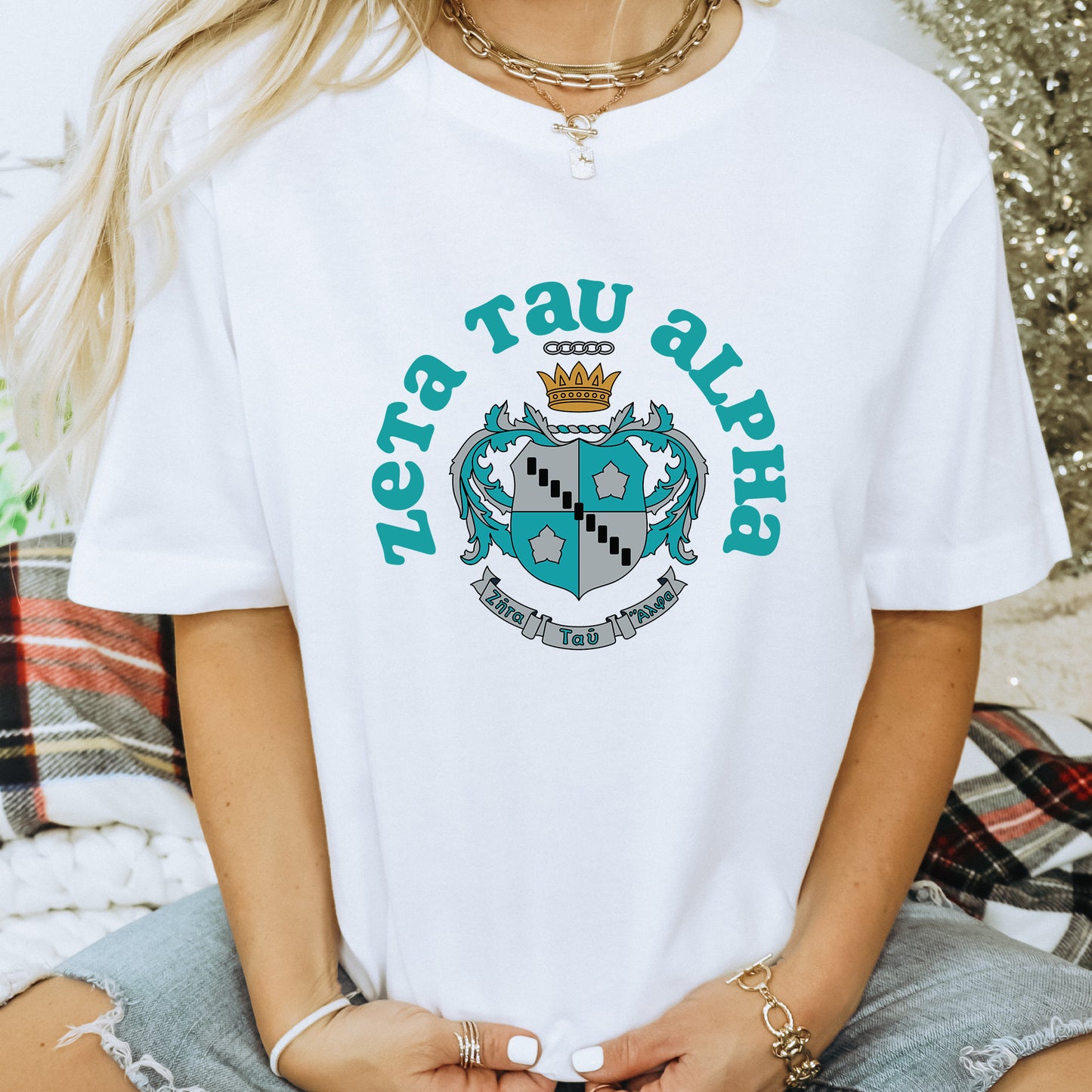 a woman wearing a white t - shirt with a crown on it