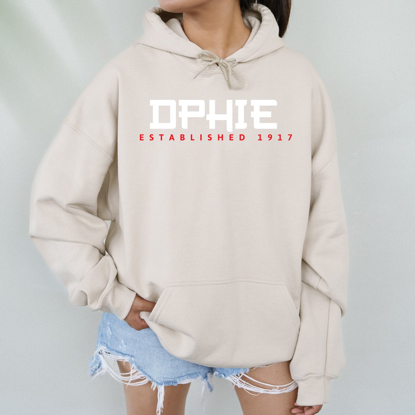 a woman wearing a white hoodie with the words ophie on it