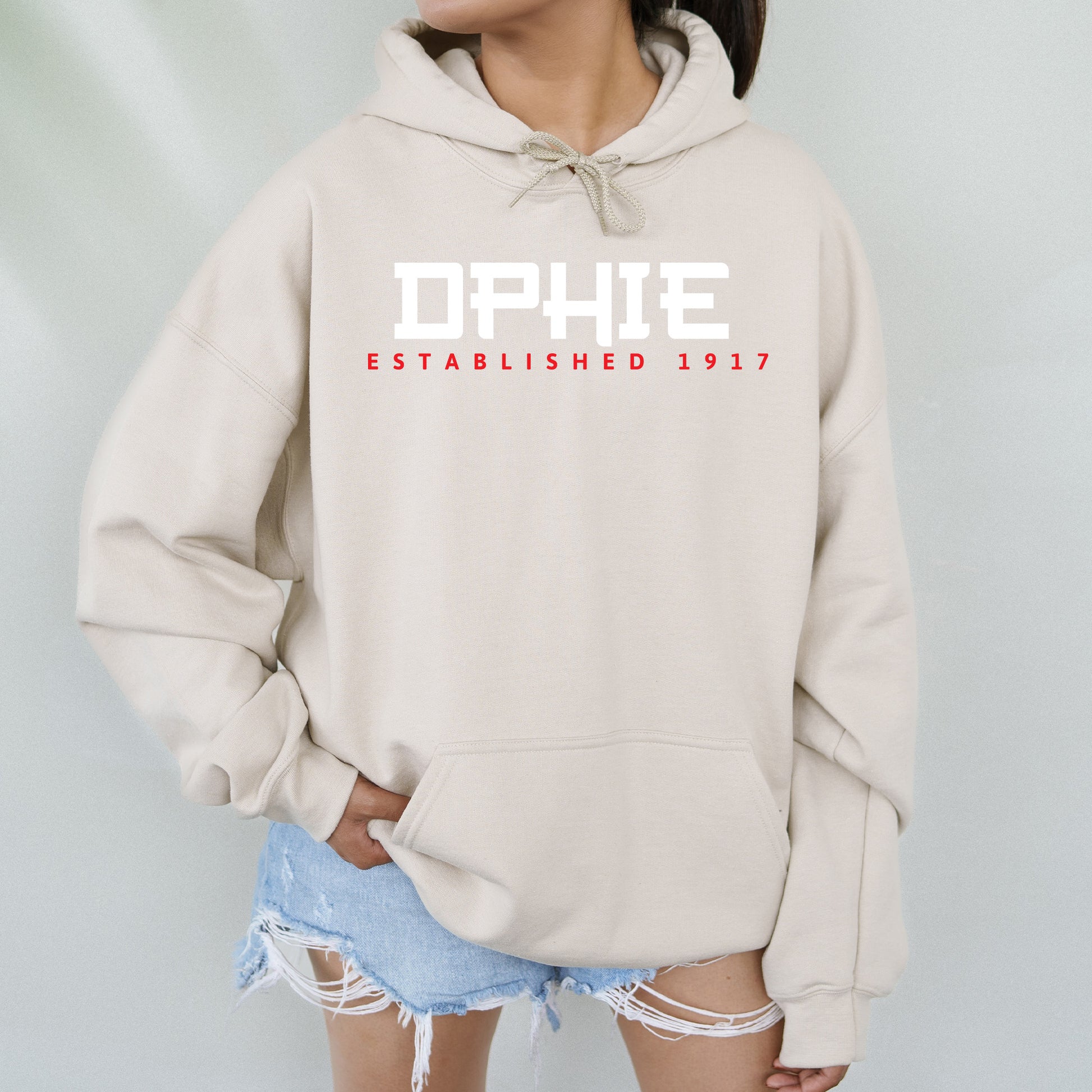 a woman wearing a white hoodie with the words ophie on it