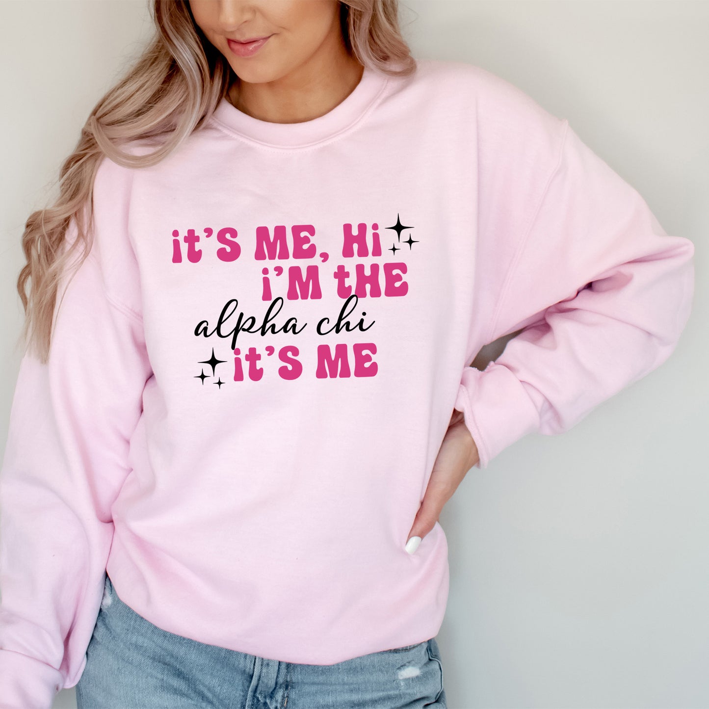 a woman wearing a pink sweatshirt that says it's me, i'm