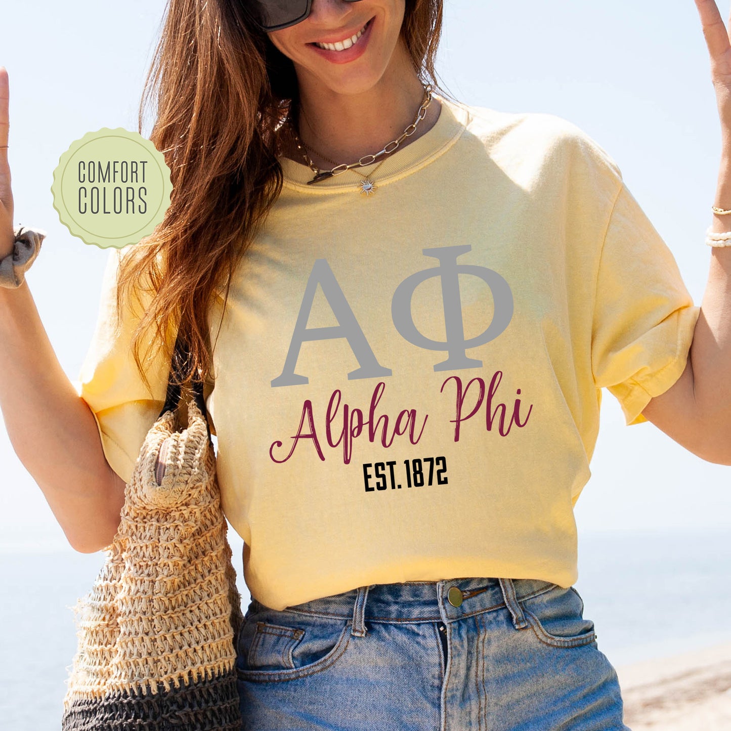 a woman in a yellow shirt holding up a peace sign