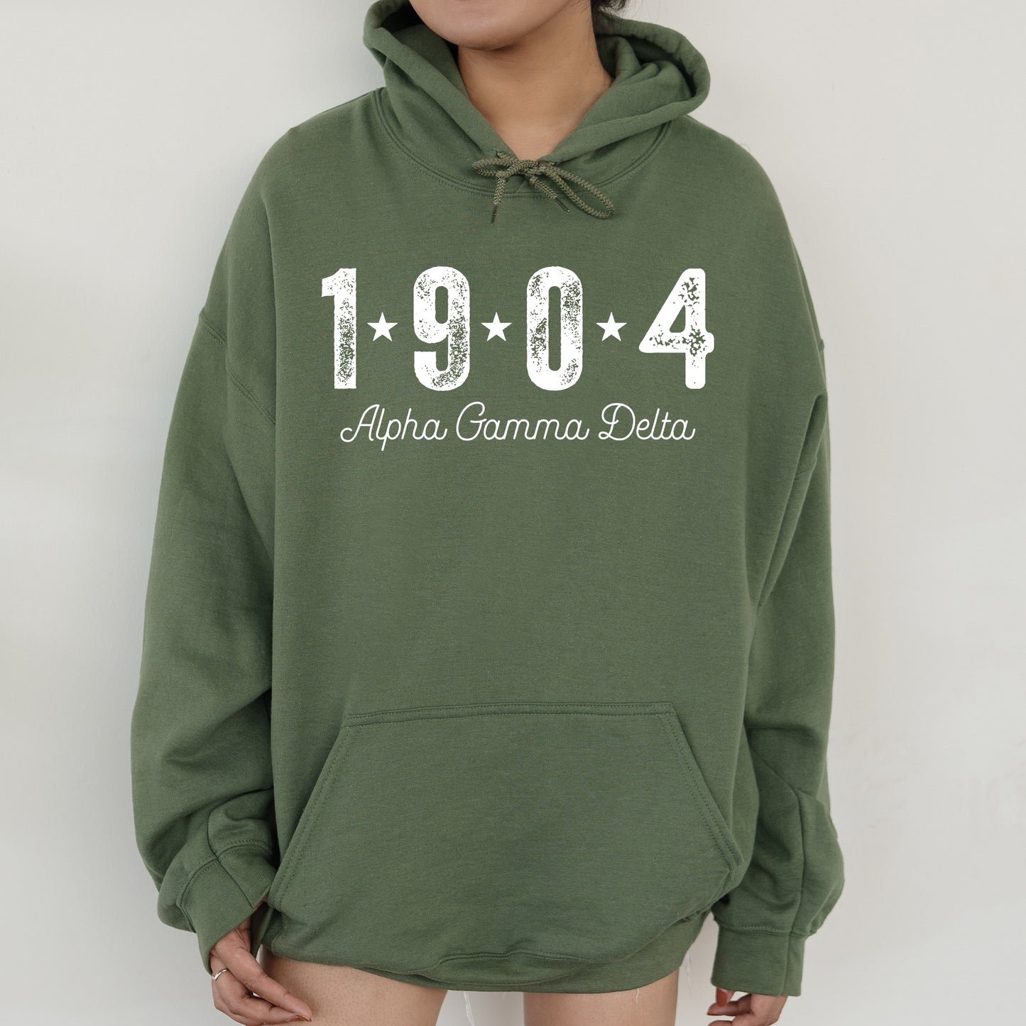 a woman wearing a green hoodie with the name of the town of abra
