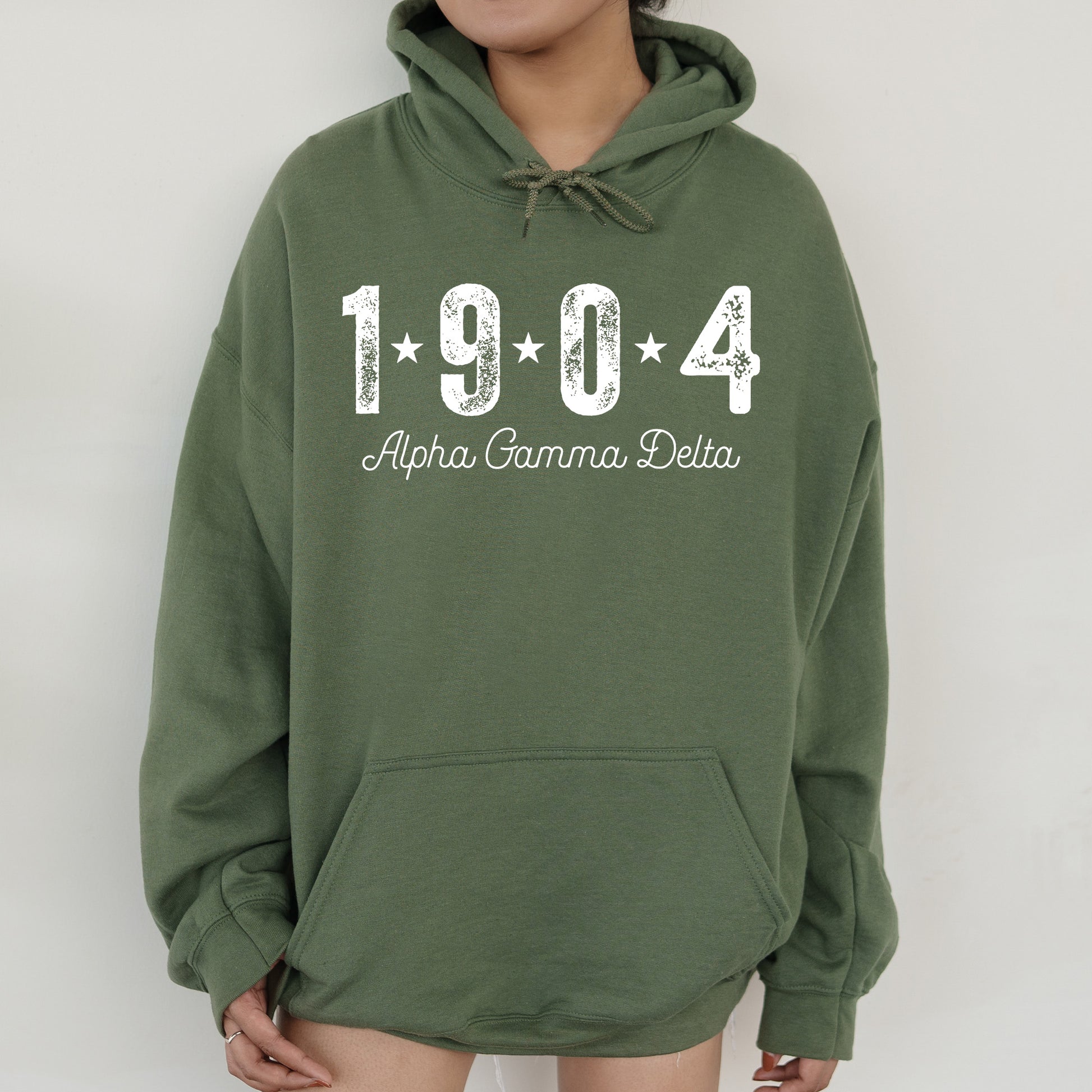 a woman wearing a green hoodie with the name of the town of abra