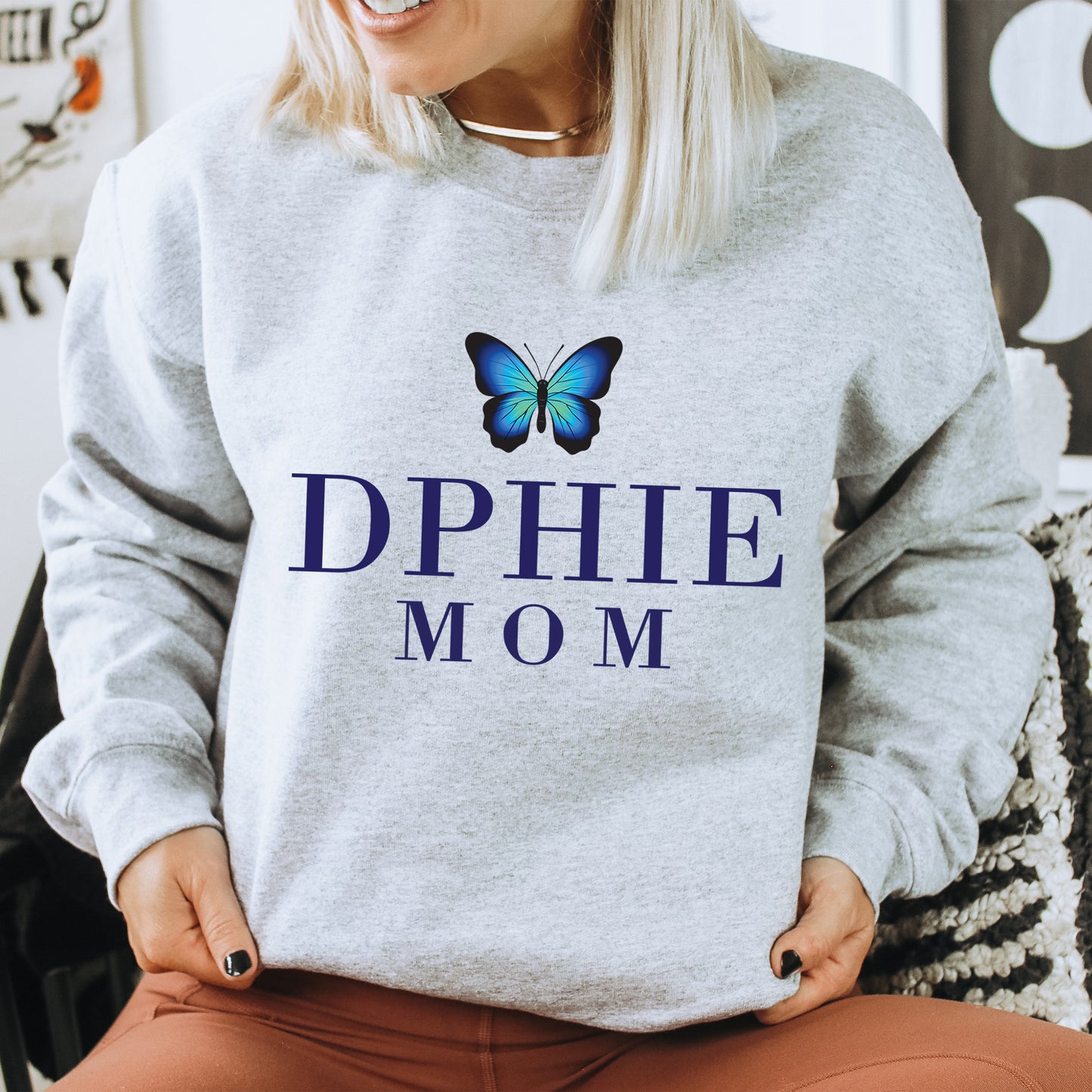 a woman wearing a sweatshirt that says dppie mom