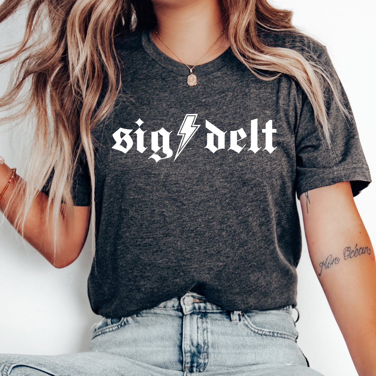 a woman wearing a black shirt with a lightning bolt on it