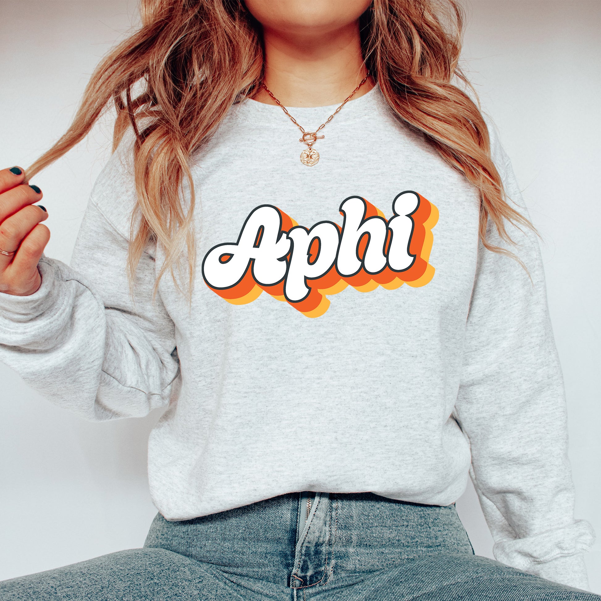 a woman wearing a sweatshirt with the word apphi on it