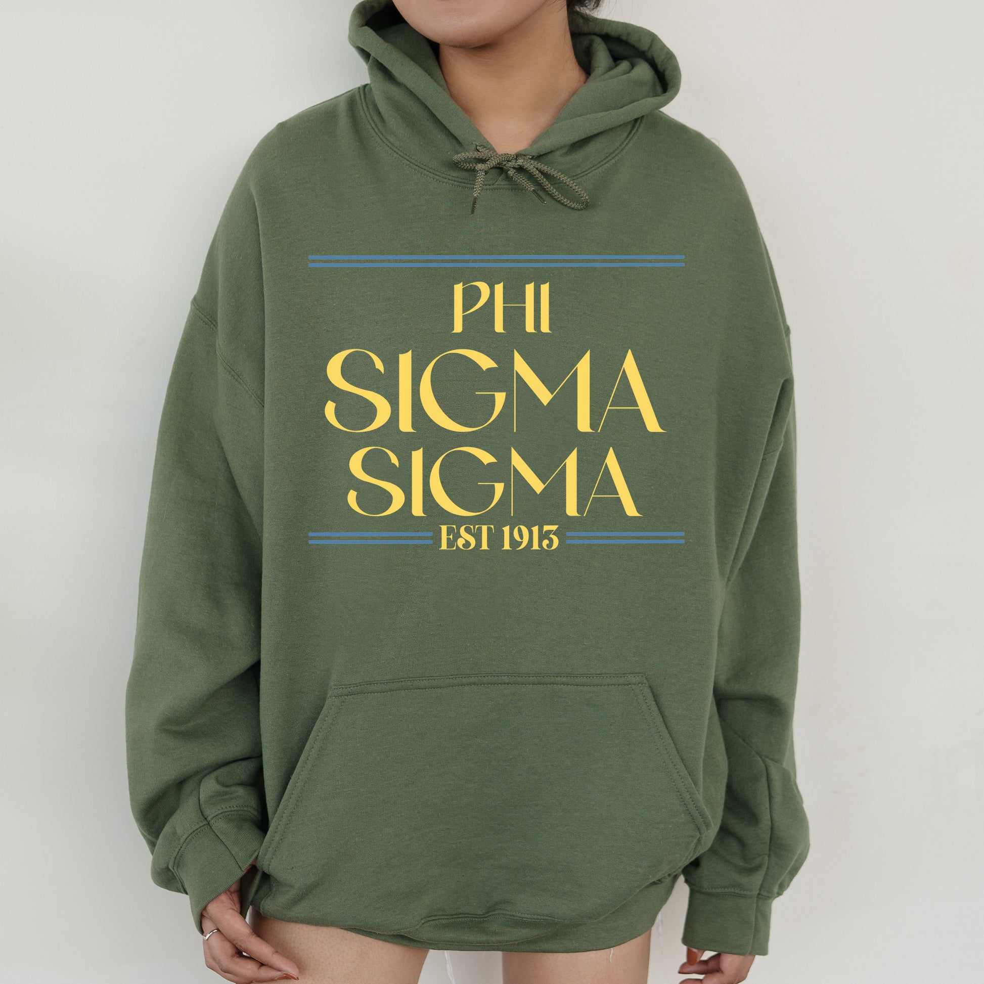 a woman wearing a green hoodie that says phi sigma sigma