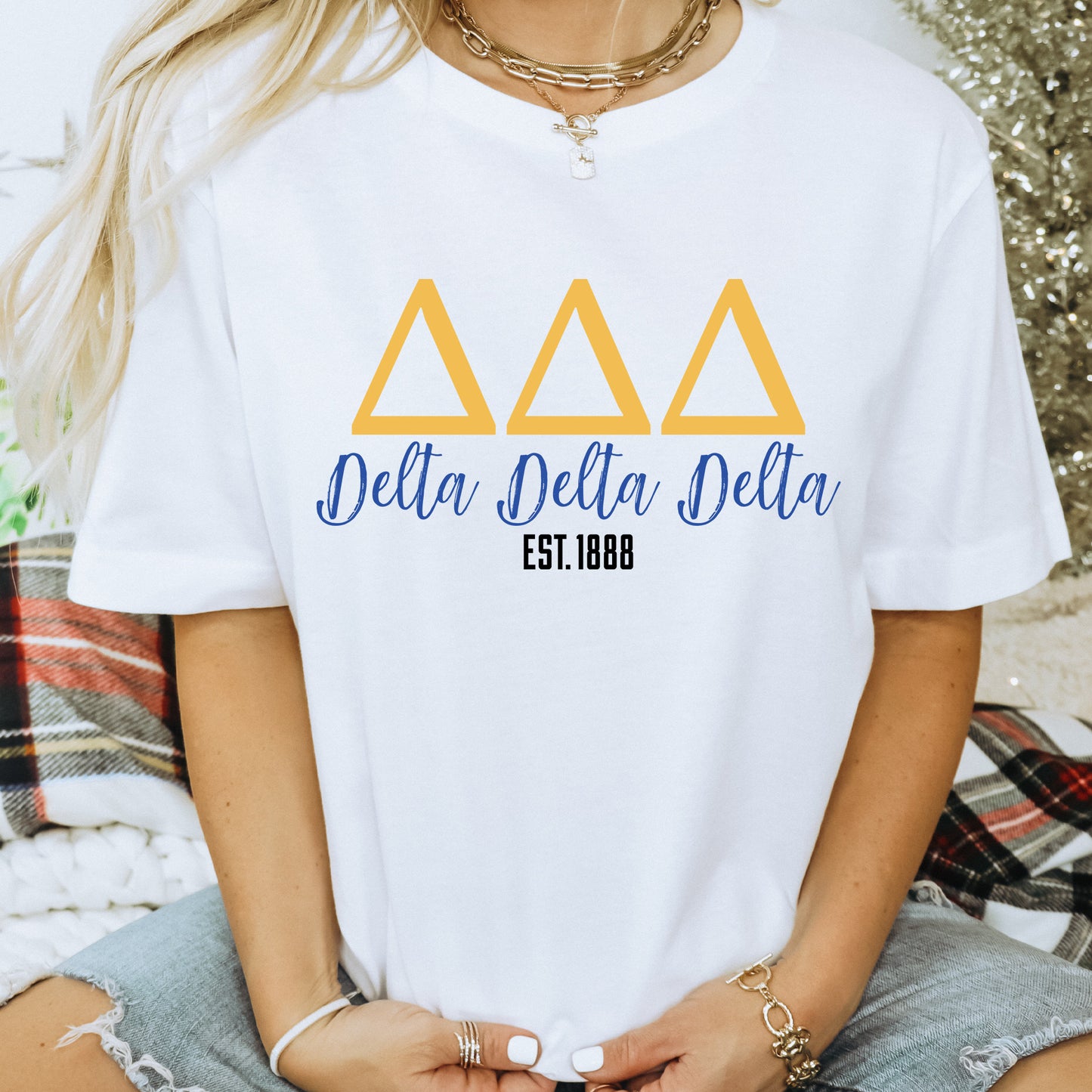 a woman wearing a delta delta delta shirt