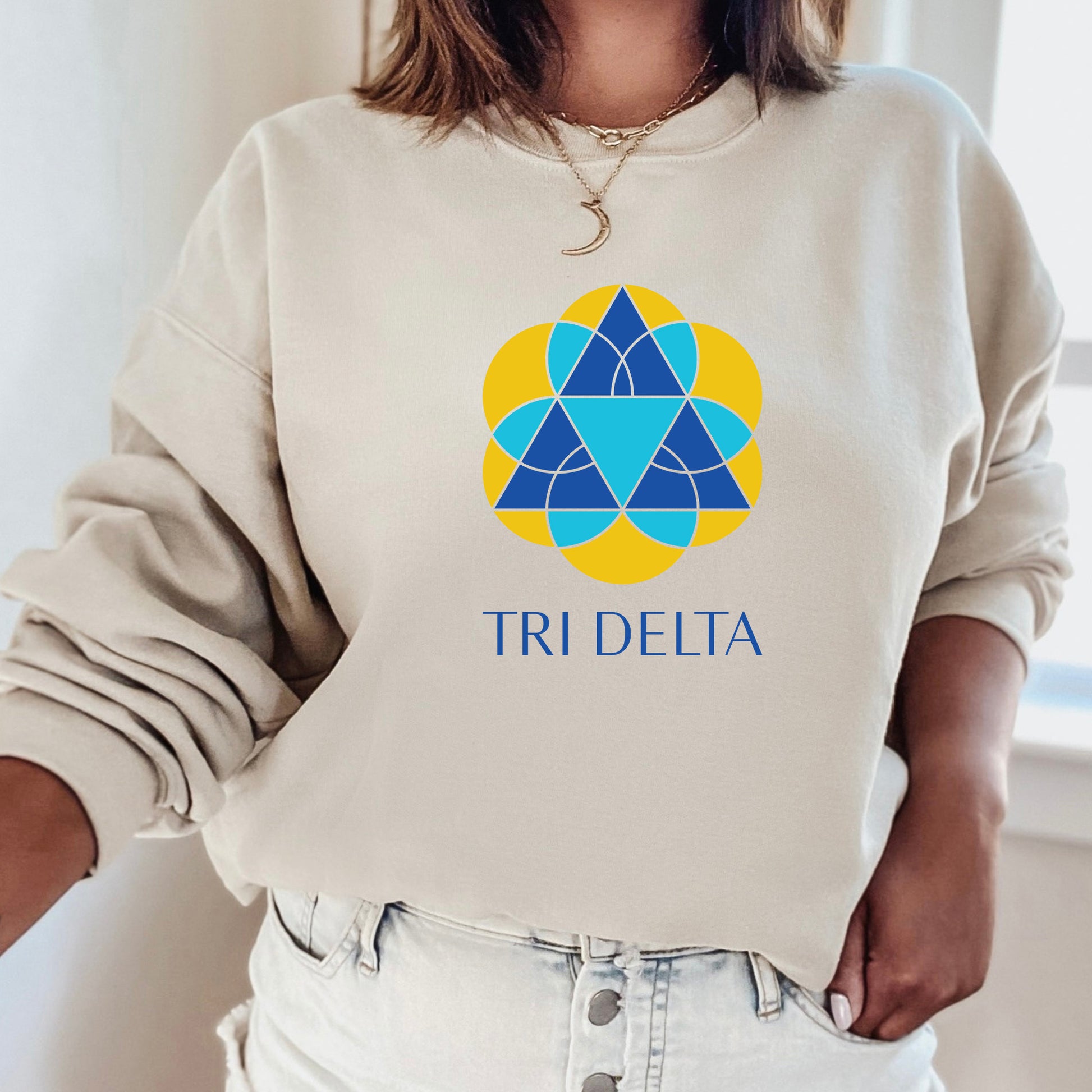 a woman wearing a sweatshirt that says tri delta