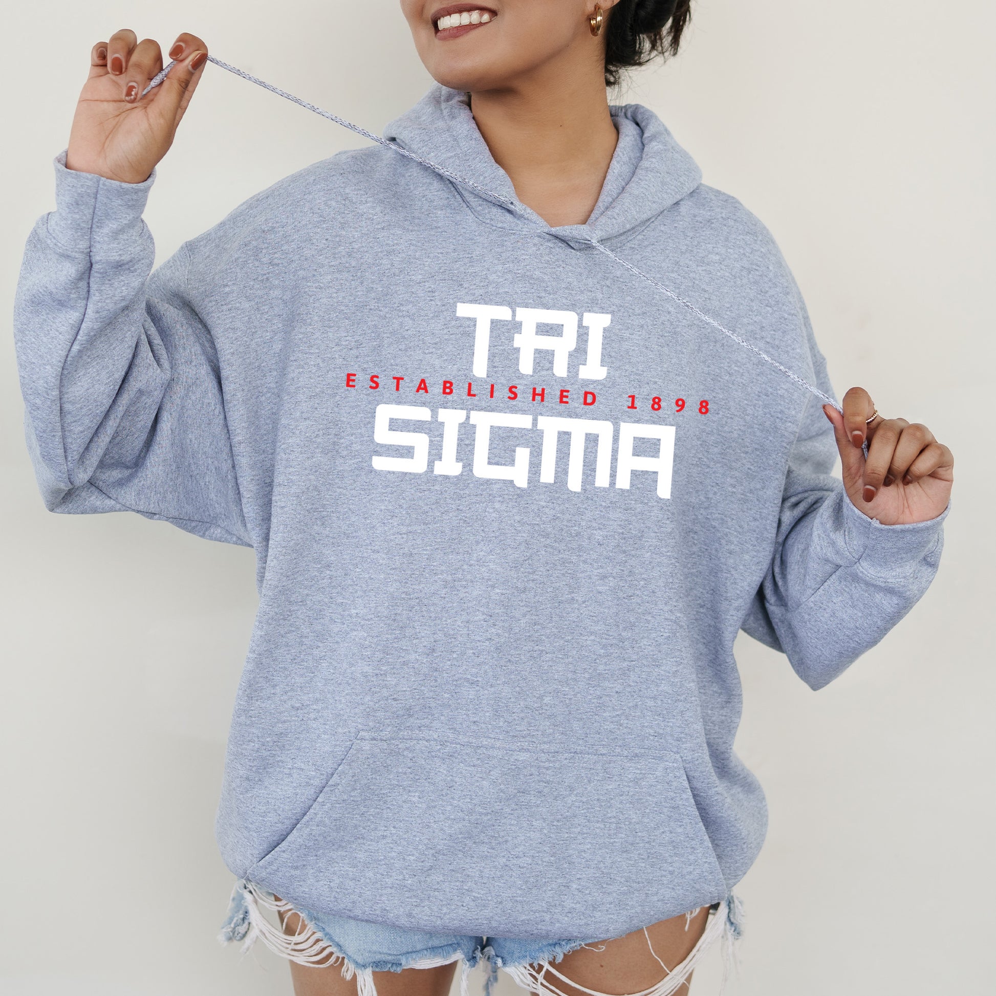 a woman in a blue hoodie holding a toothbrush