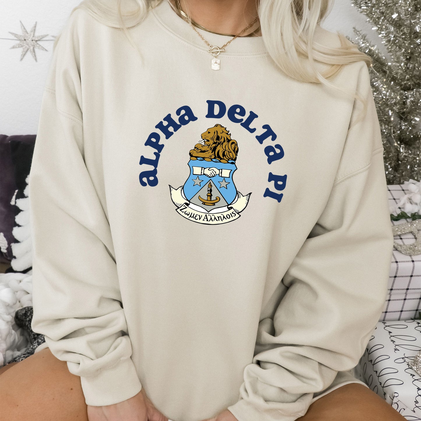 a woman sitting on a couch wearing a sweatshirt