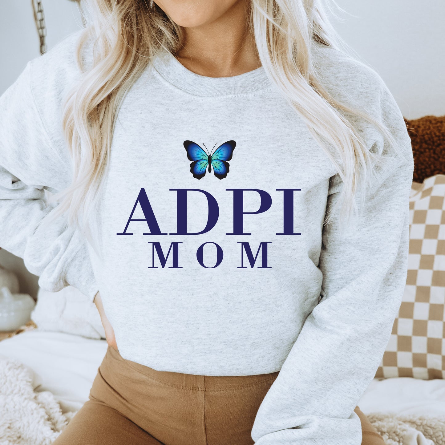a woman wearing a sweatshirt with a butterfly on it