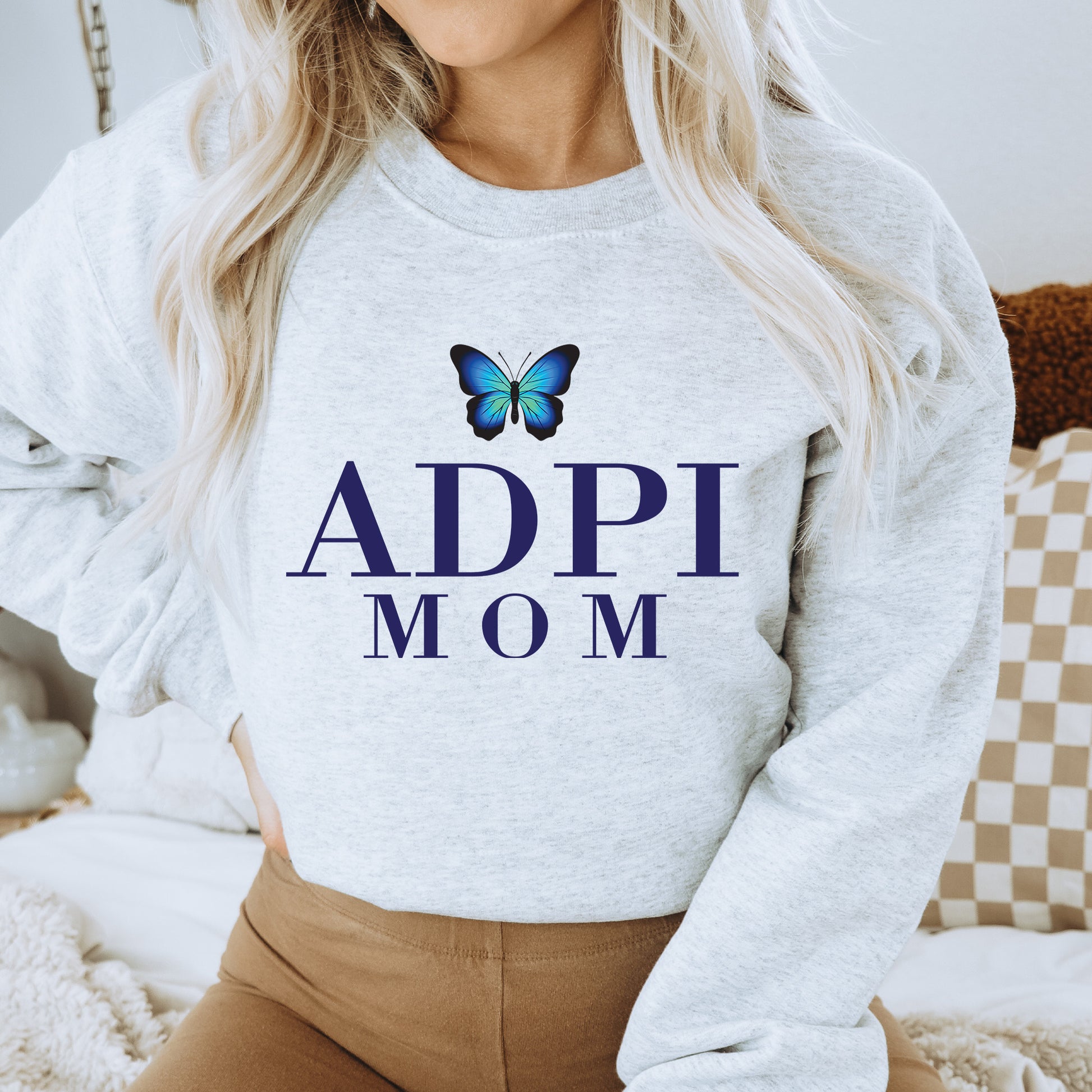 a woman wearing a sweatshirt with a butterfly on it