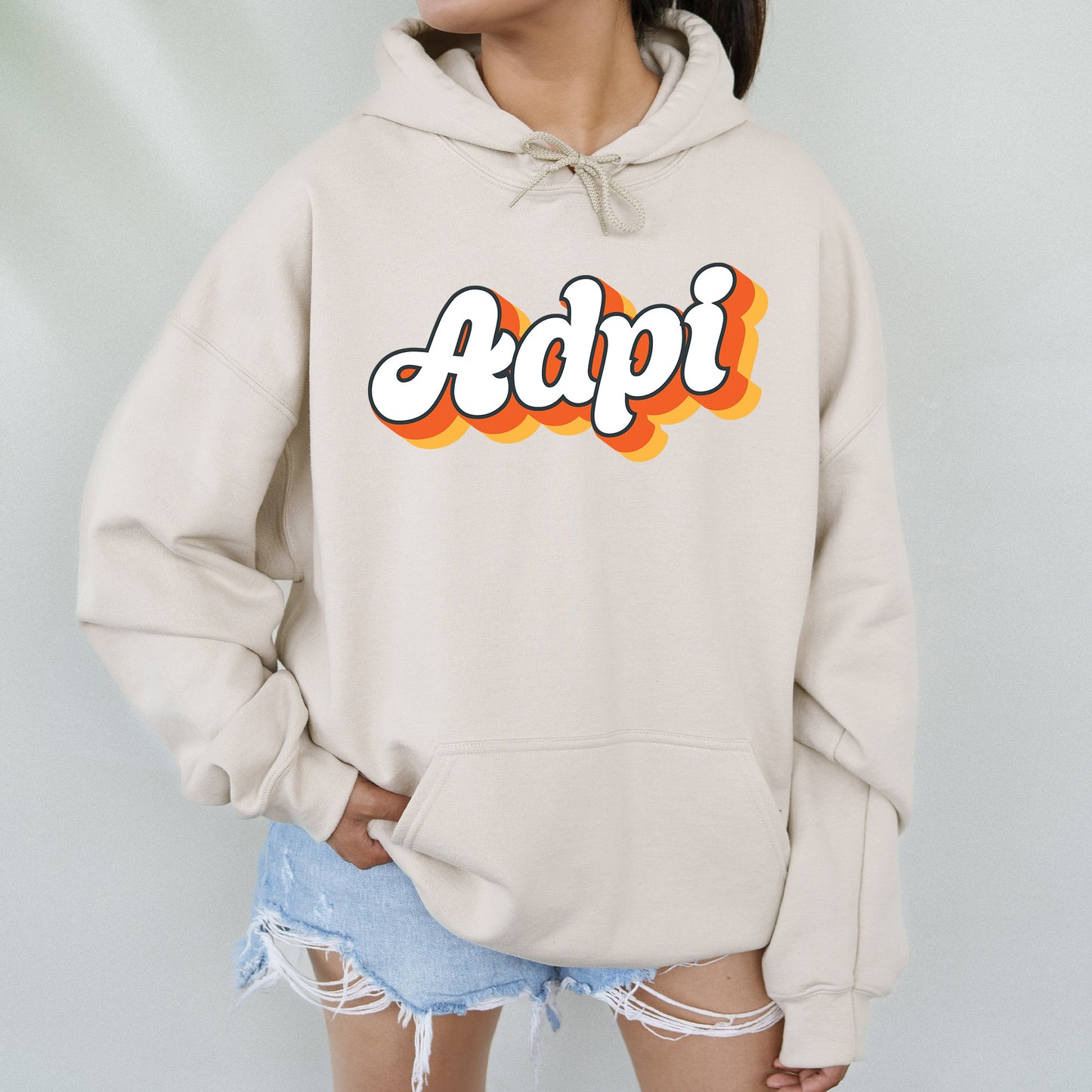 a woman wearing a hoodie with the word adpi printed on it