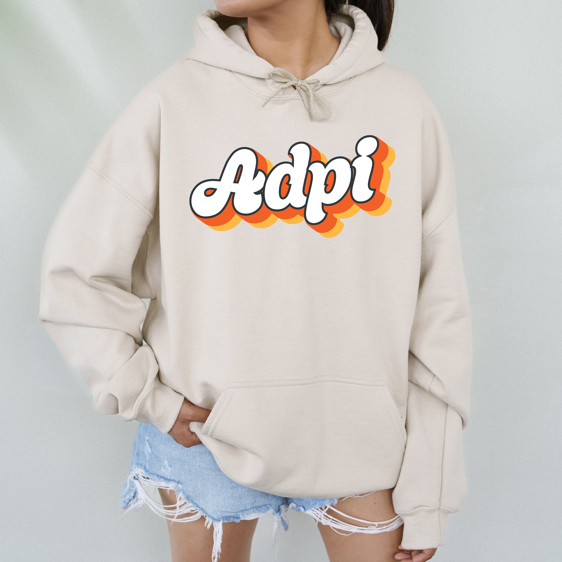 a woman wearing a hoodie with the word adpi printed on it