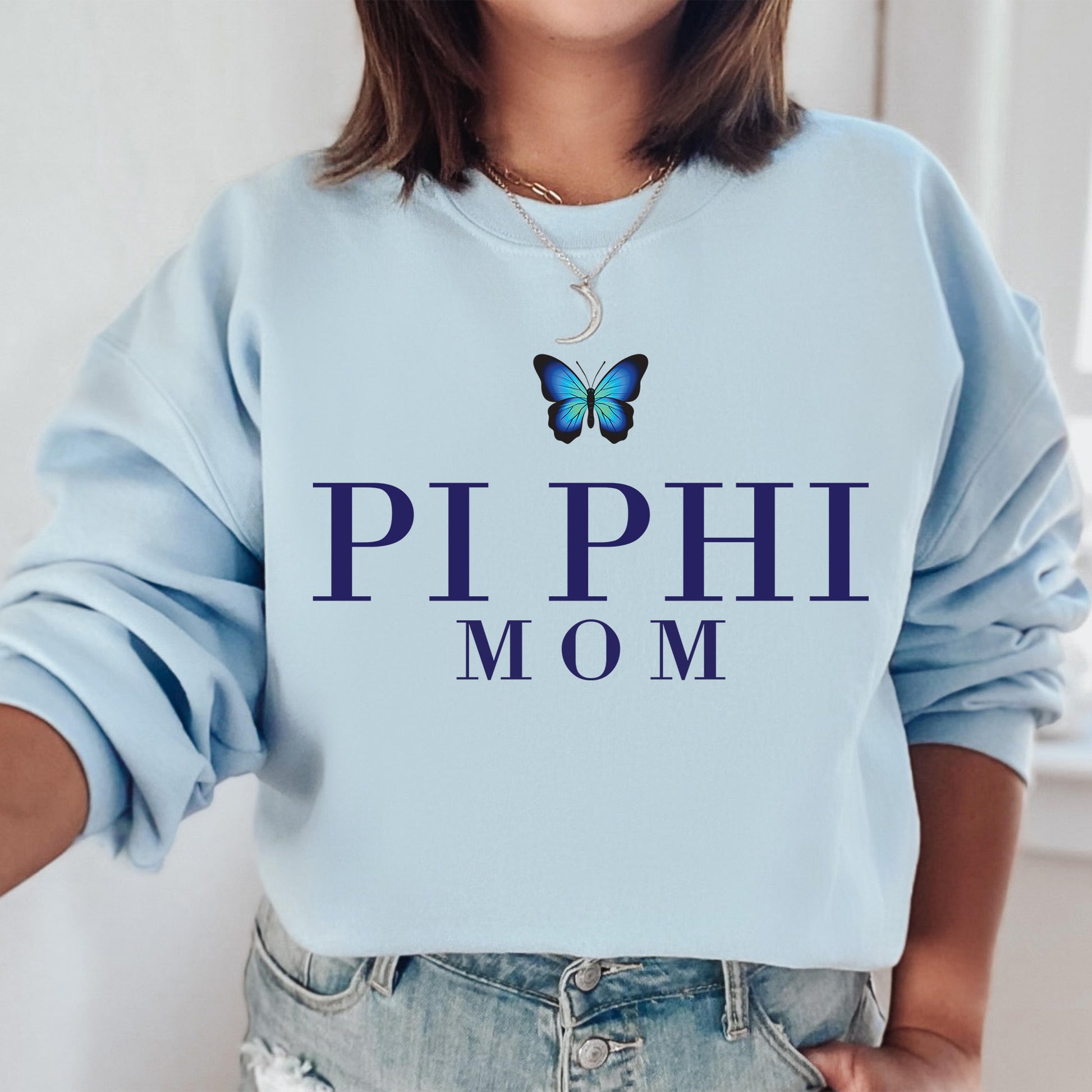 a woman wearing a blue sweatshirt with a butterfly on it