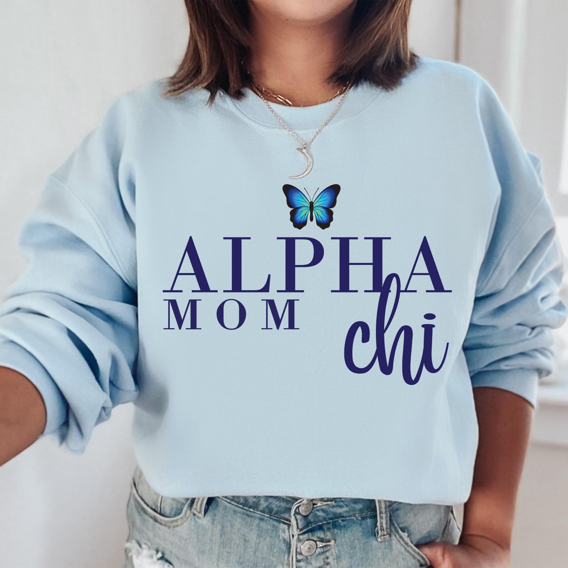 a woman wearing a blue sweatshirt with a butterfly on it
