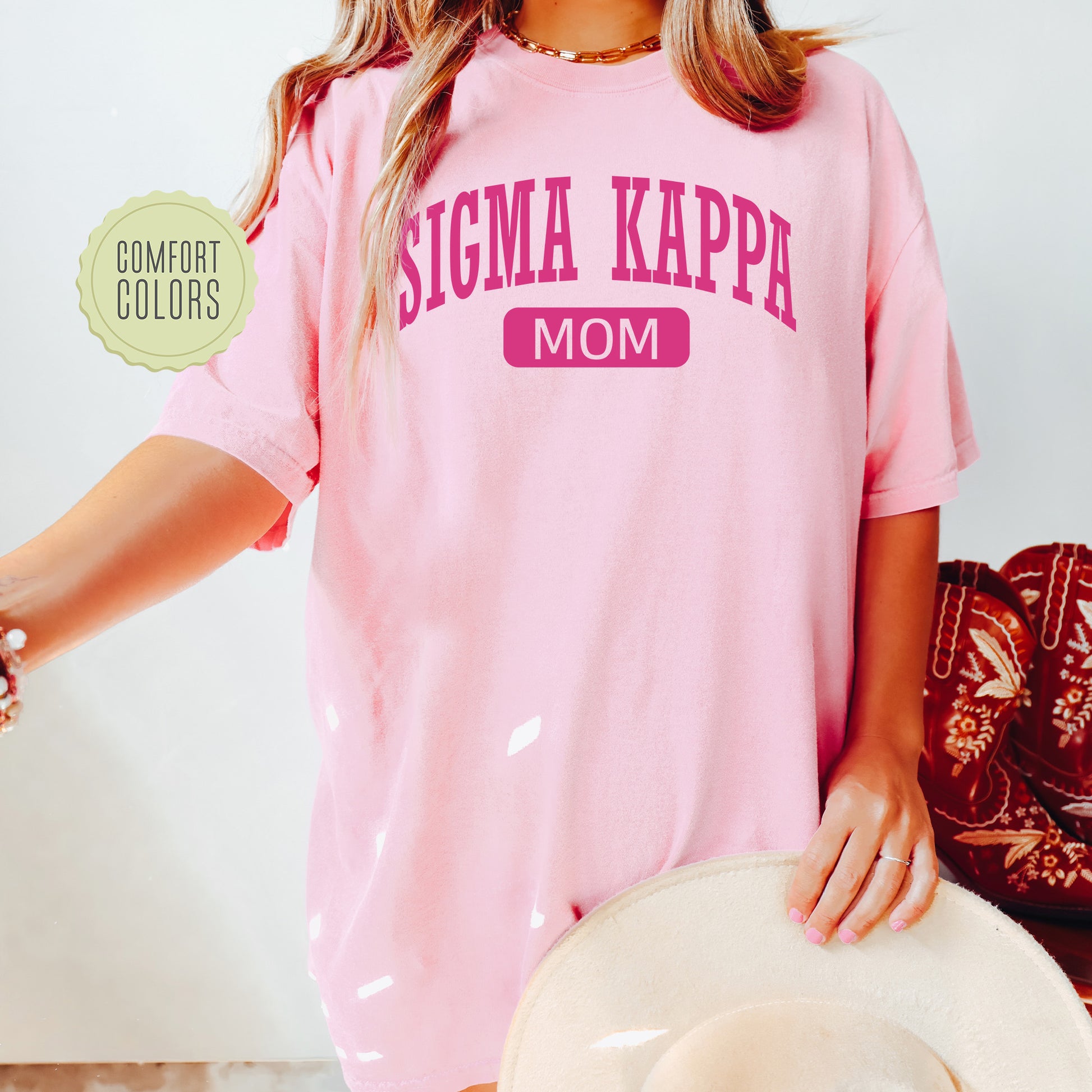 a woman wearing a pink shirt and hat