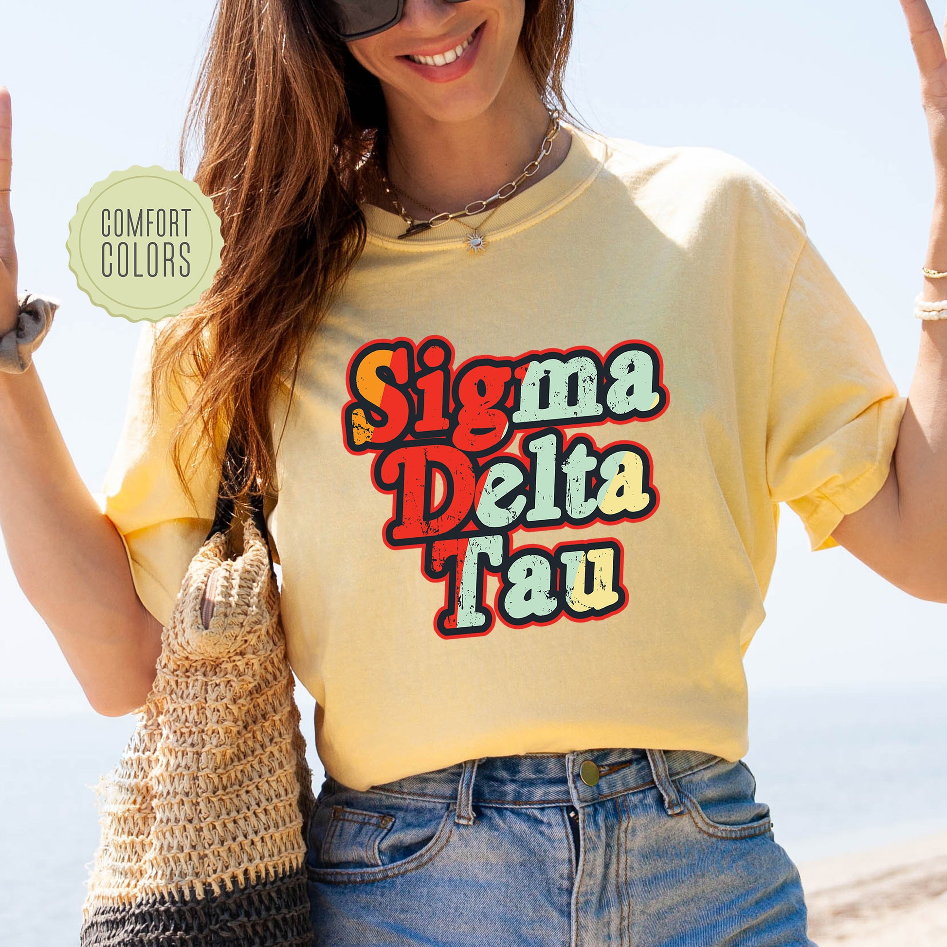 a woman in a yellow shirt is holding up a peace sign