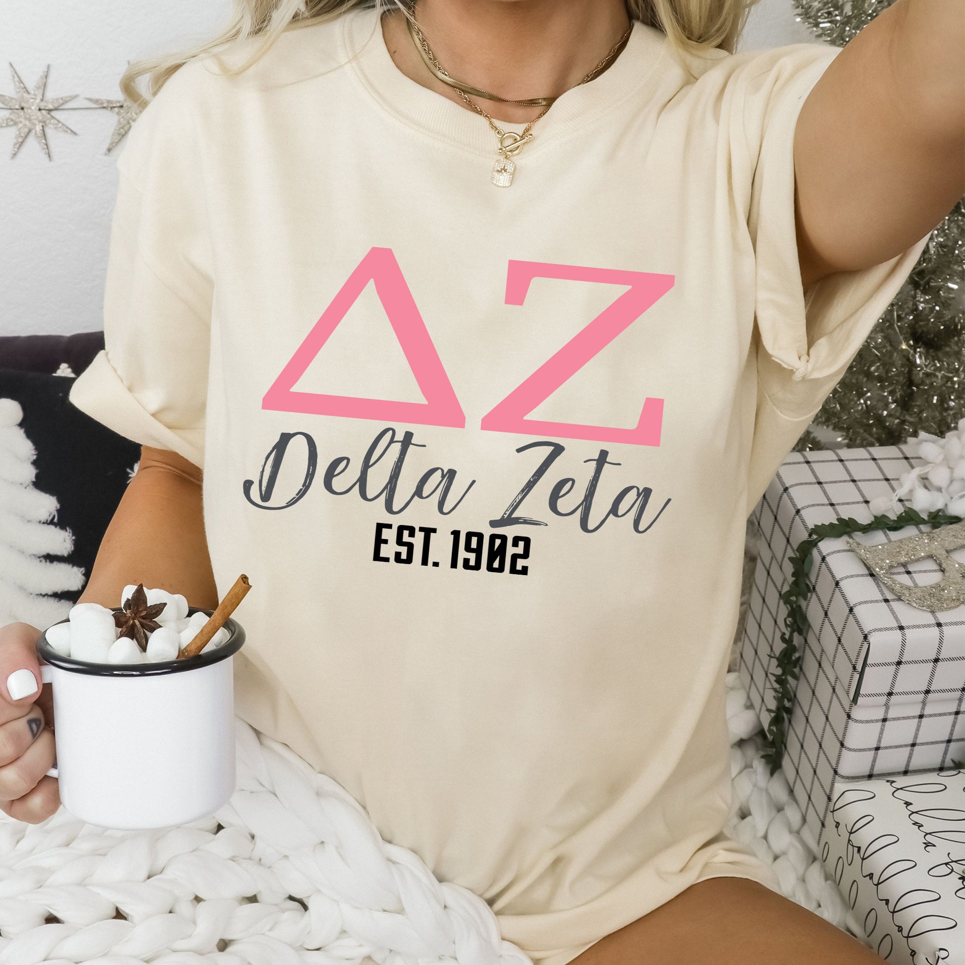 a woman sitting on a bed holding a cup of coffee