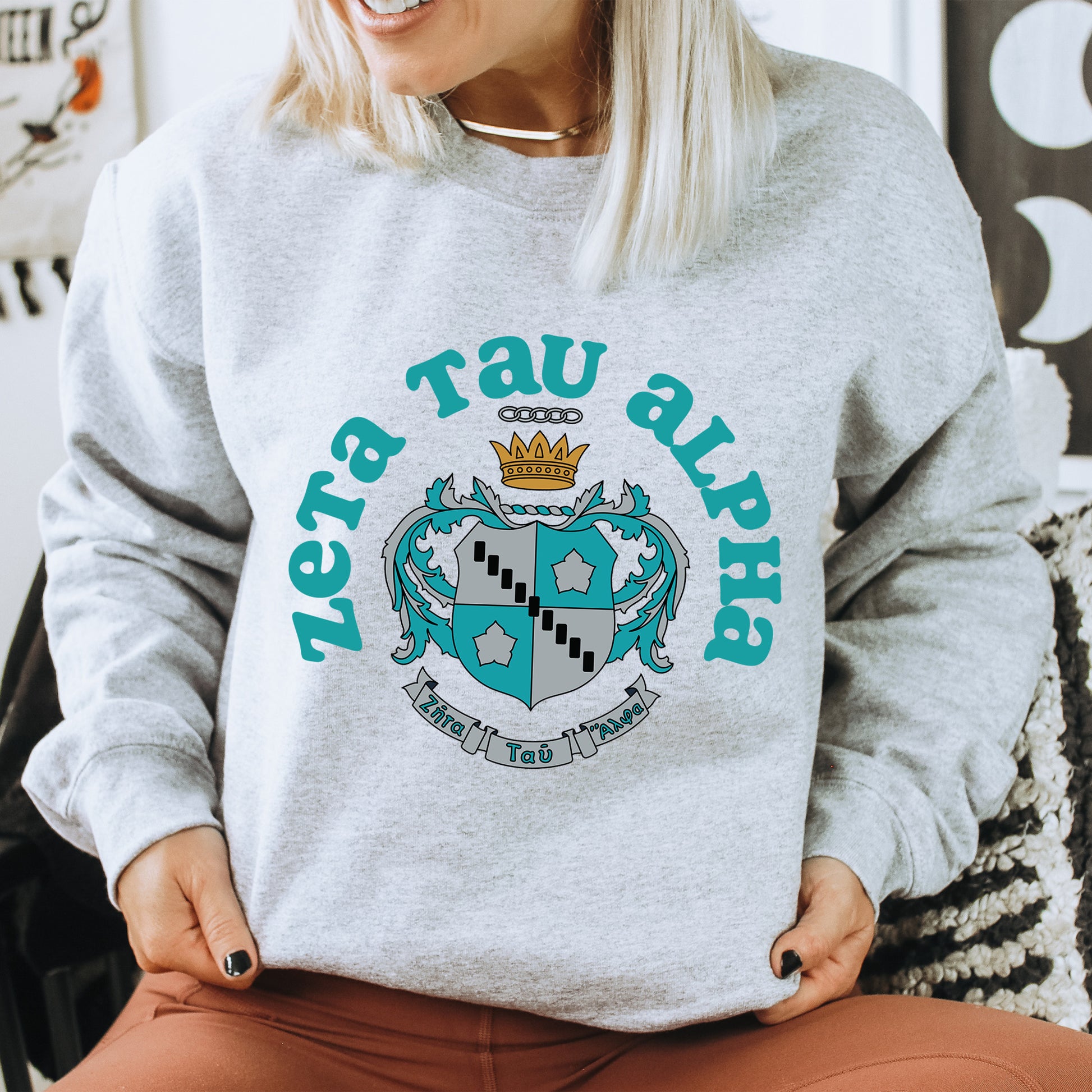 a woman sitting on a chair wearing a sweater