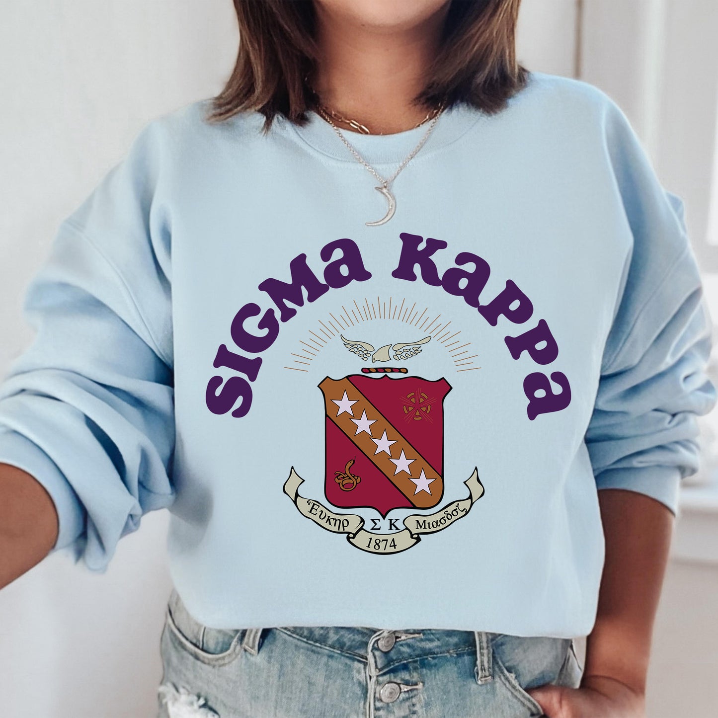 a woman wearing a blue sweater with a crest on it