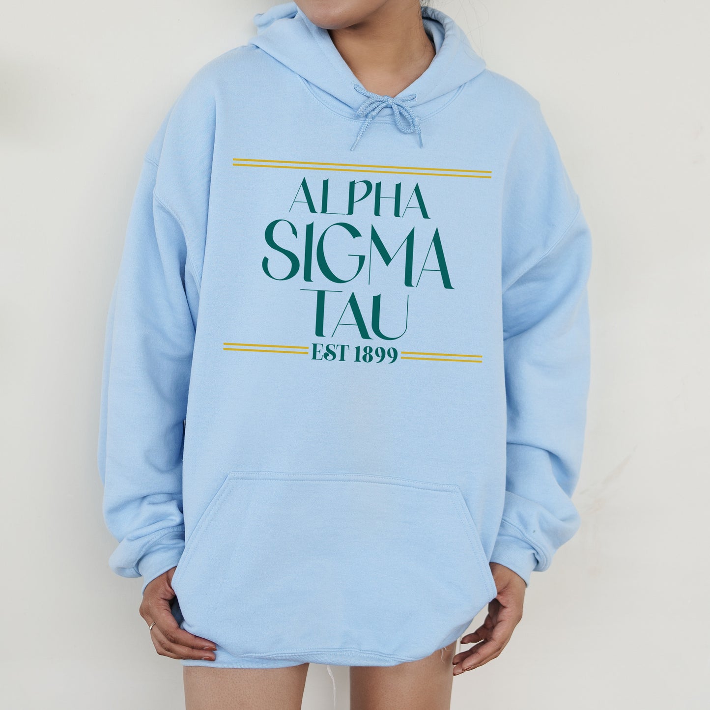 a person wearing a blue hoodie with a green and yellow logo