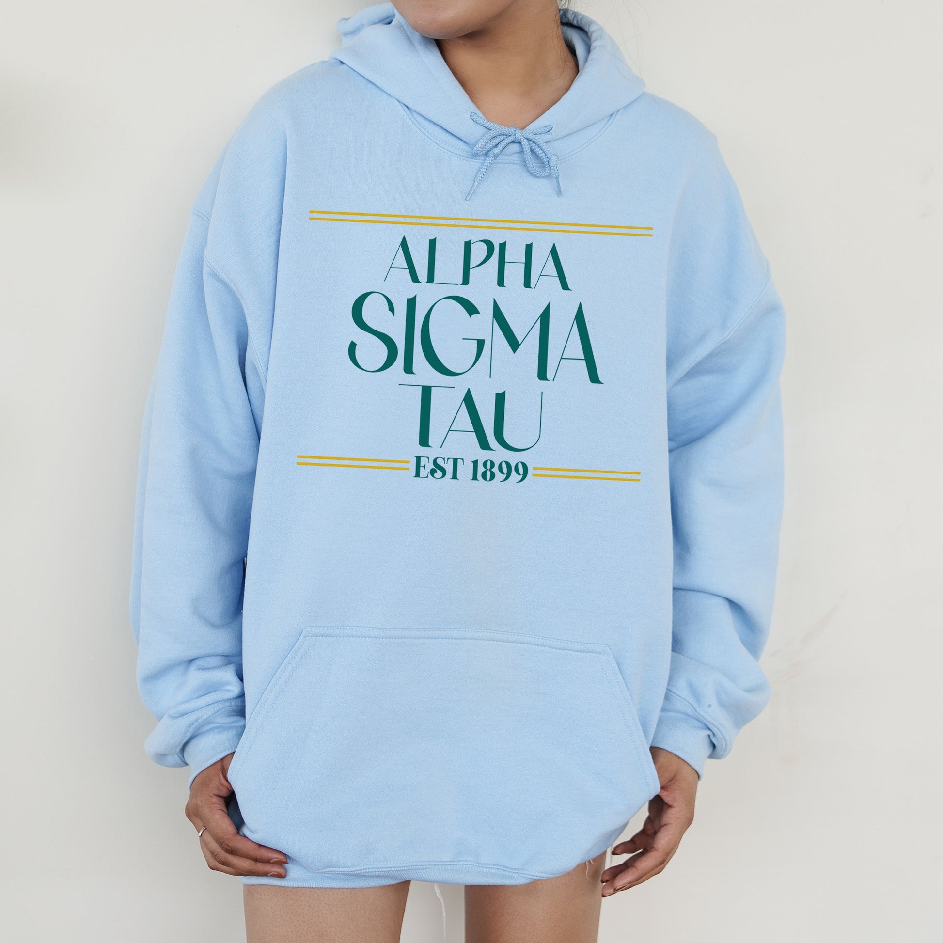 a person wearing a blue hoodie with a green and yellow logo