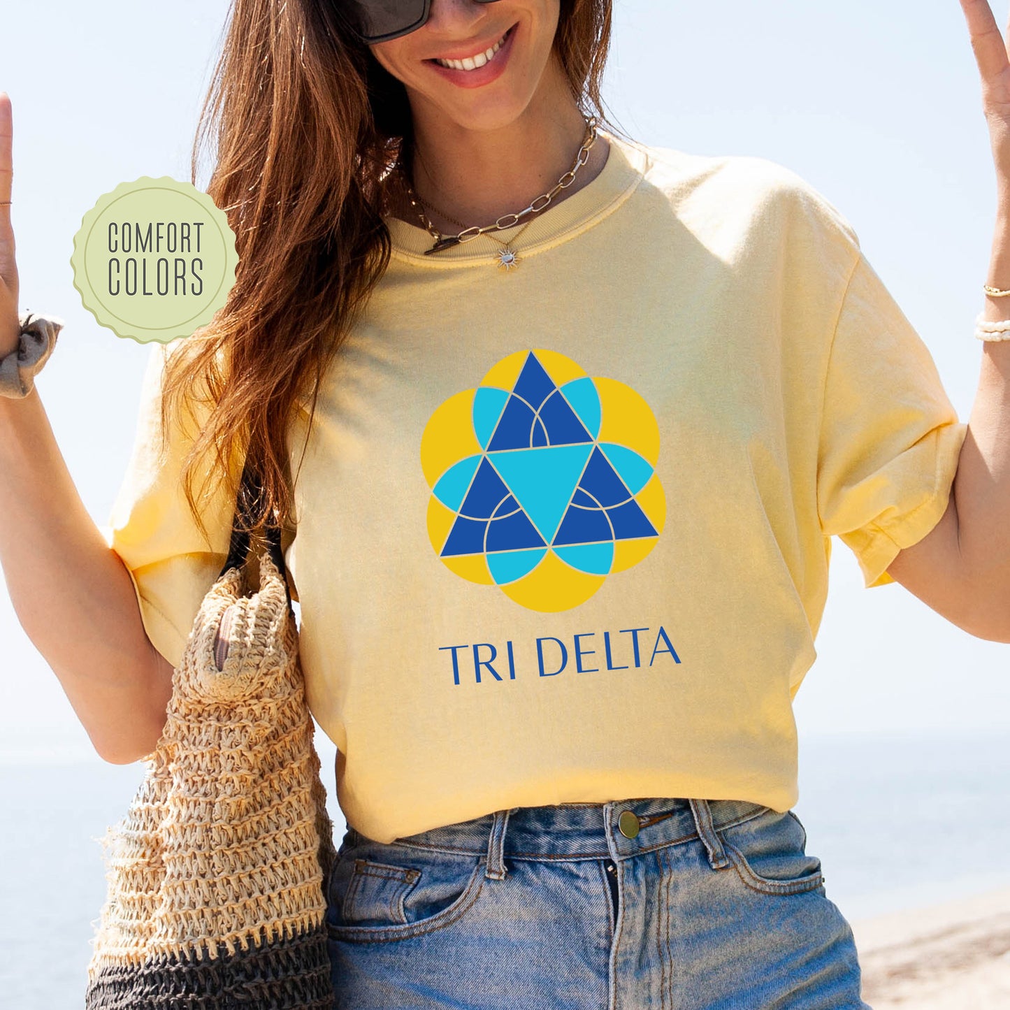 a woman wearing a t - shirt that says tridelta
