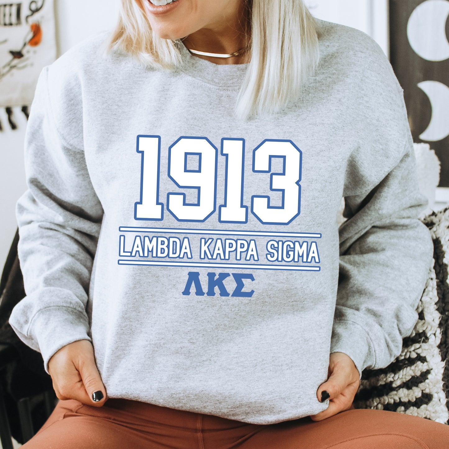 a woman sitting in a chair wearing a sweatshirt